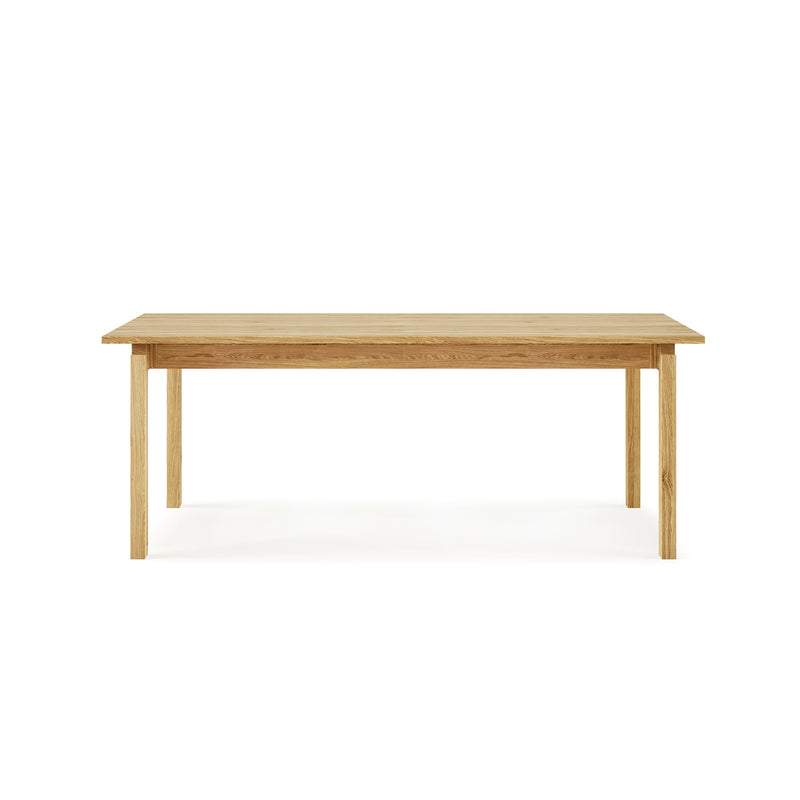 A minimalist Gus Modern Annex Extendable Dining Table with a light wood finish, straight legs, and a smooth rectangular top is shown against a white background, highlighting its simple elegance.