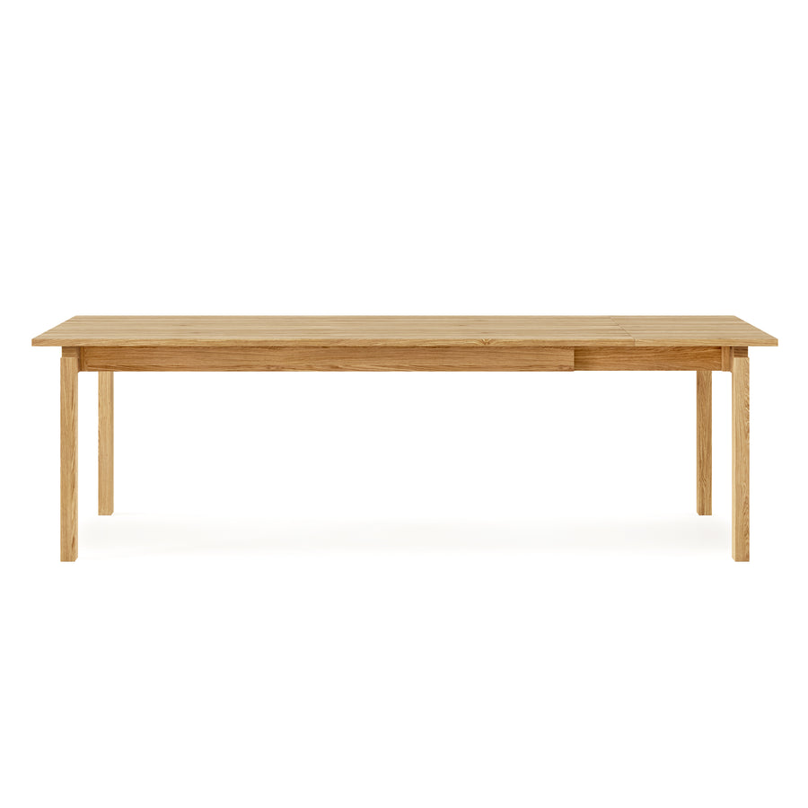The Gus Modern Annex Extendable Dining Table is a rectangular wooden table with four straight legs and a smooth surface, shown against a white background.