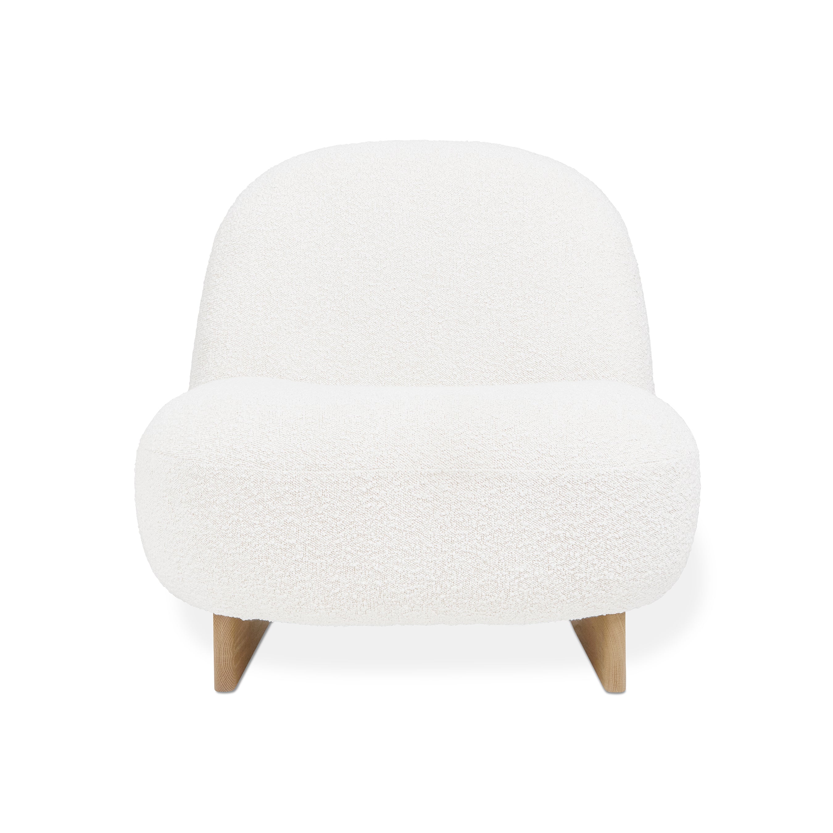 The Arlo Chair by Gus Modern showcases Scandinavian style with a rounded, armless lounge design, upholstered in white bouclé and supported by short, angled wooden legs.