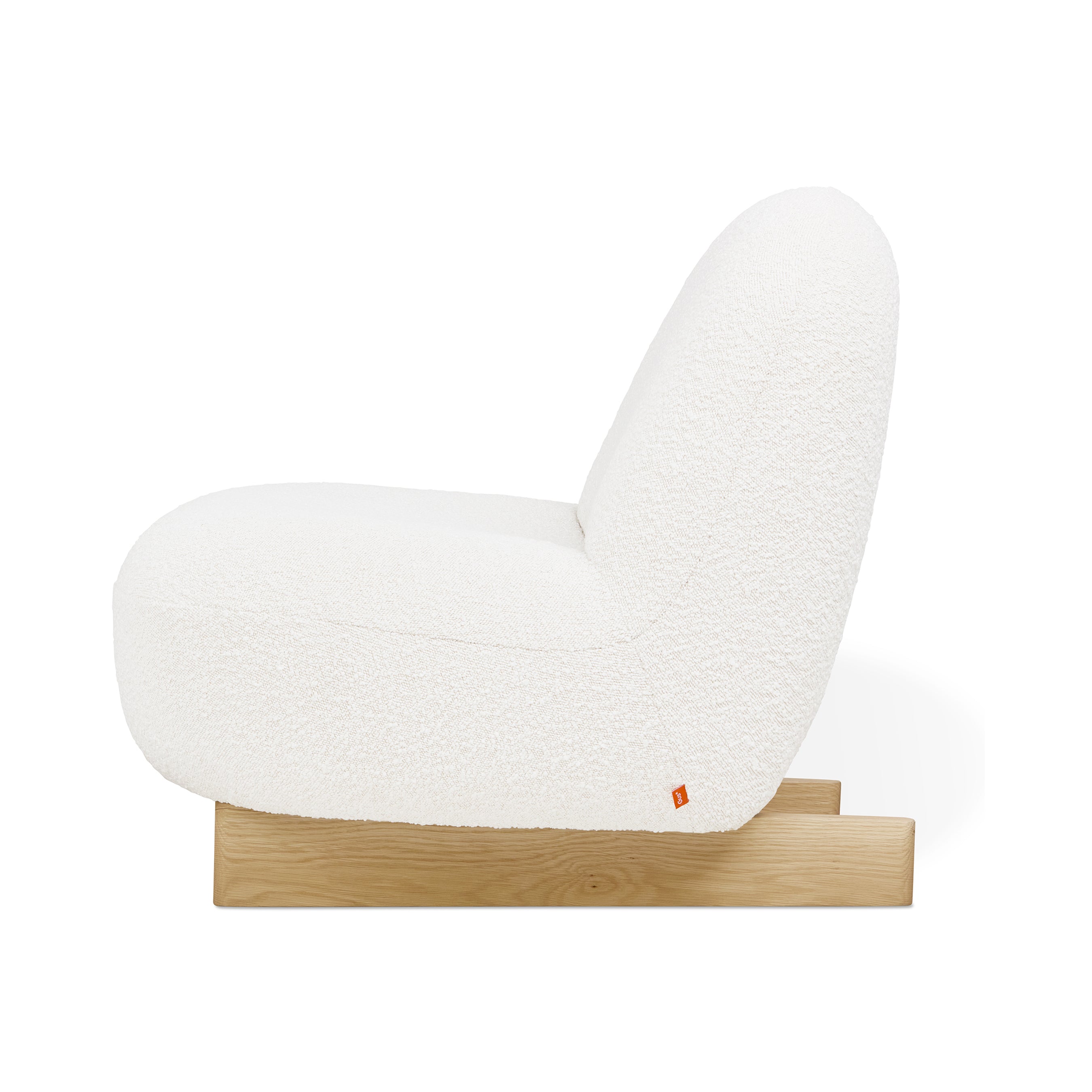 Side view of the Arlo Chair by Gus Modern, showcasing a white bouclé fabric seat and backrest on a low, light wood base. This minimalist lounge chair highlights contemporary Scandinavian-inspired design with a textured look.
