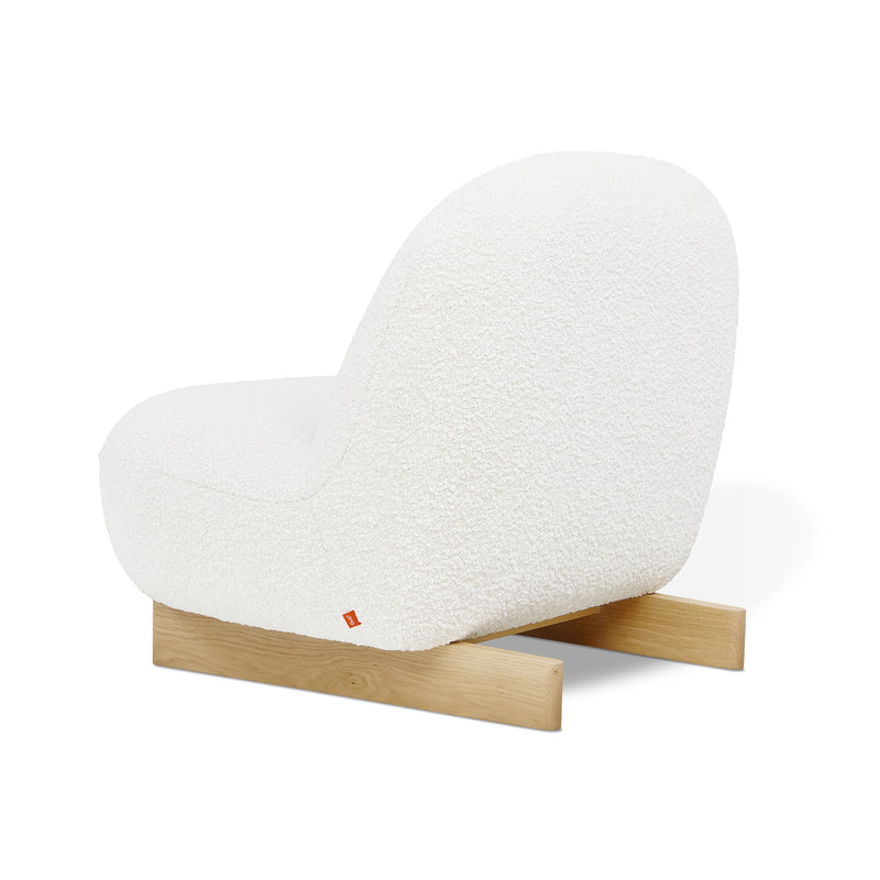 The Arlo Chair by Gus Modern features a modern white bouclé upholstered seat with a rounded back, supported by two simple light wooden legs, shown on a white background.