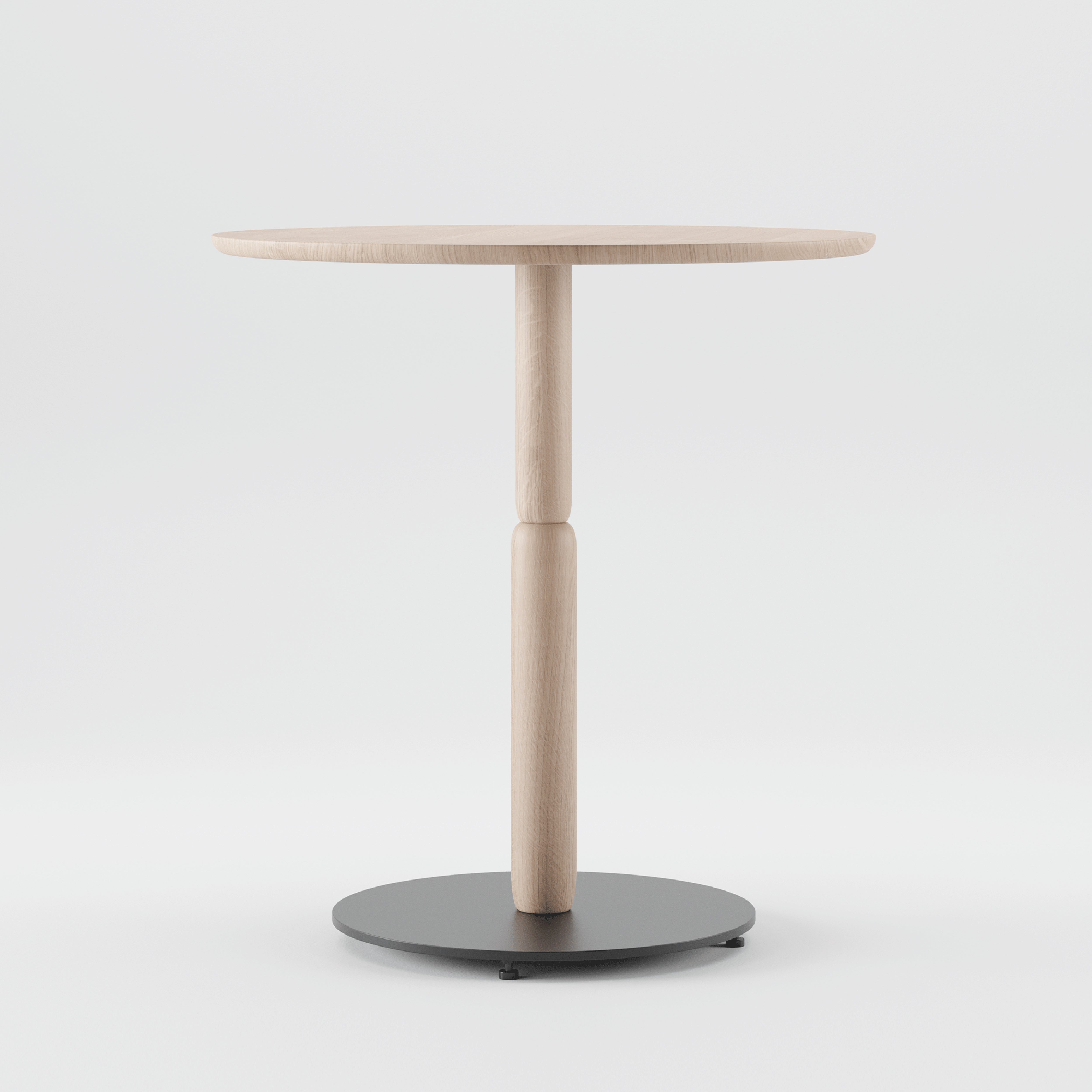 The Bistro A Table by Artisan is a minimalist, round table with a slender central support on a circular black base, crafted from solid wood. Set against a plain white background, it uses eco-friendly materials, prioritizing renewable resources without compromising style.