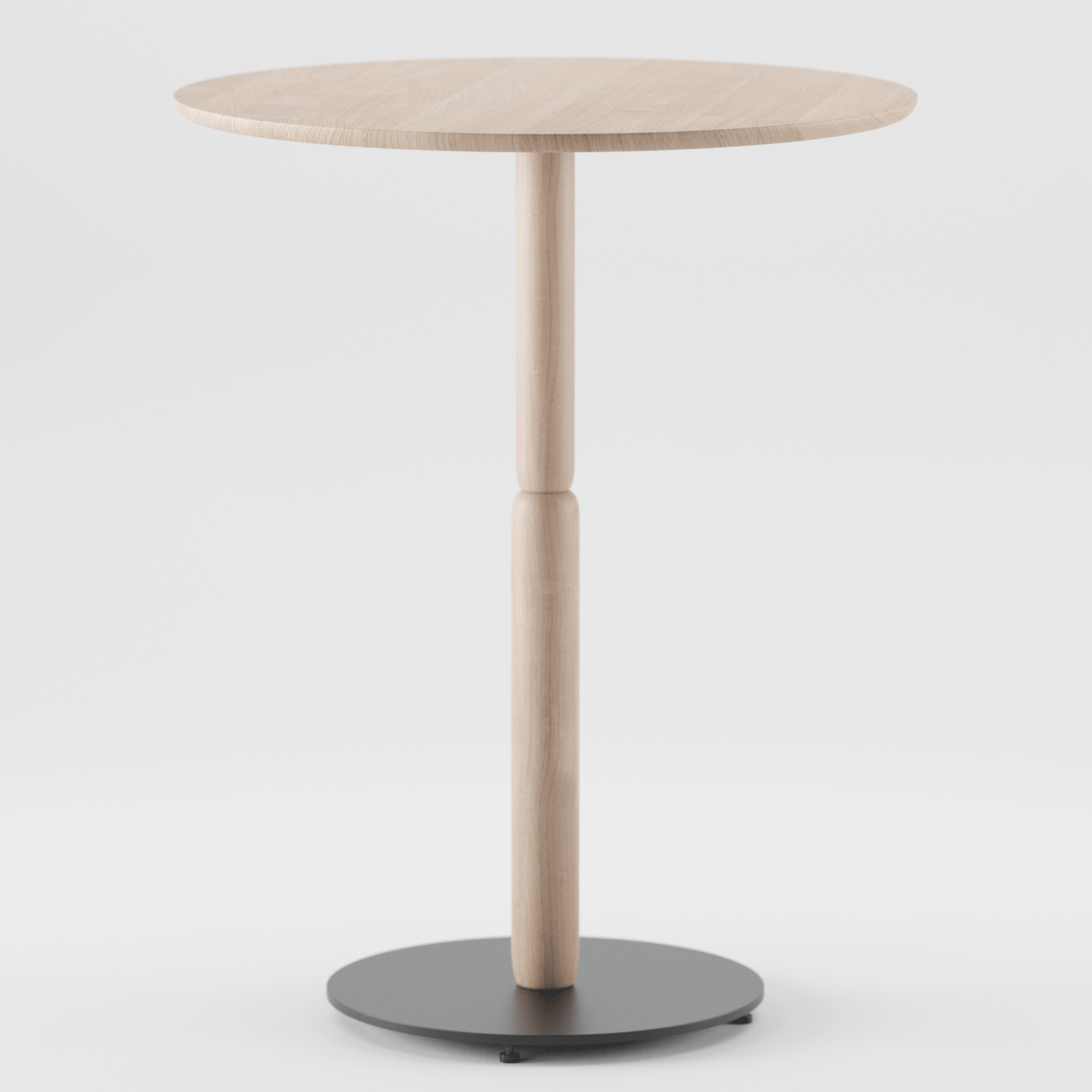 The Bistro A Table by Artisan is a small, round wooden table with a minimalist design made from solid wood. It features a light finish and stands on a single central leg with a round black metal base, crafted from environmentally-friendly materials against a white background.