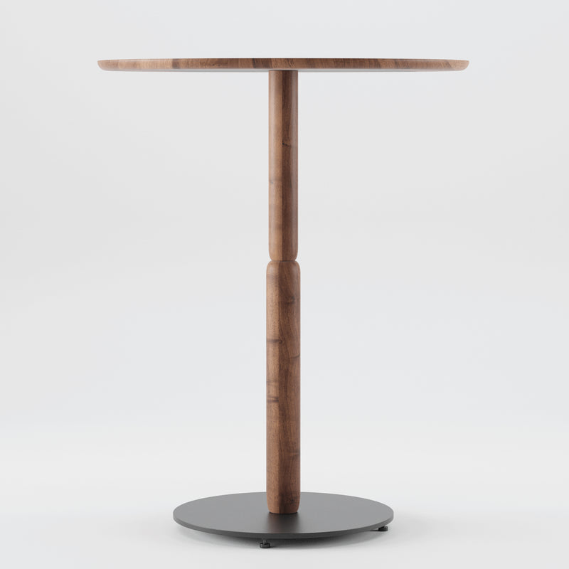 The Artisan Bistro A Table features a solid wood design with a round top and slender central support. It elegantly stands on a circular black base against a white background, highlighting the beauty of eco-friendly materials.