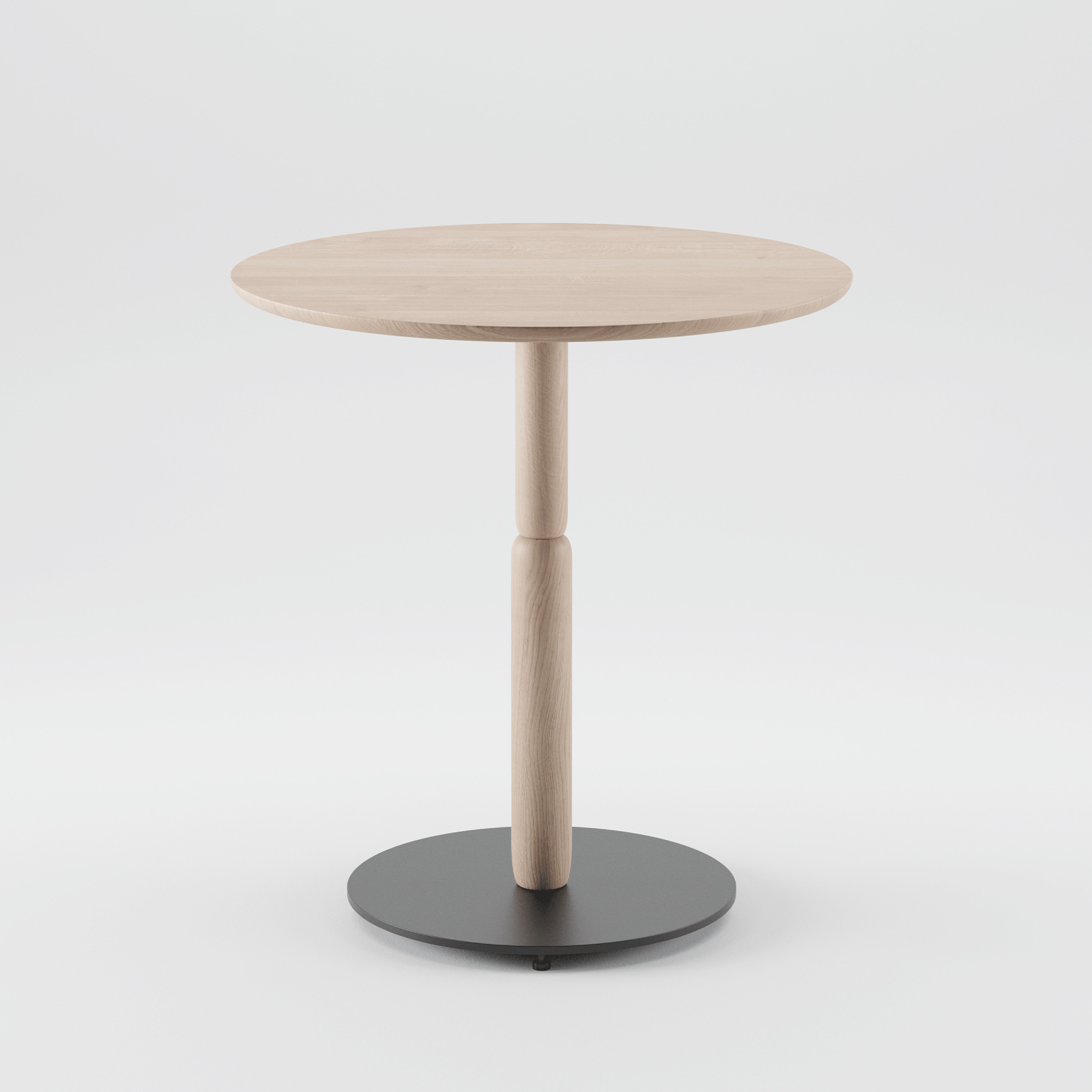 The Bistro A Table by Artisan is a minimalist round wooden table made from solid, eco-friendly materials. It features a central support and a sleek black circular base, all set against a plain white background.
