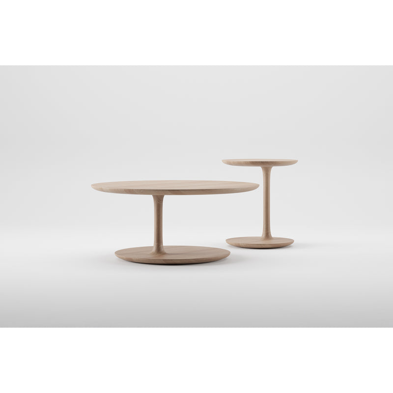 The BLOOP Coffee Tables by Artisan, from the Bloop collection, boast round wooden tops and sleek pedestal bases. The taller, smaller table and the shorter, larger one rest on a smooth white surface against a plain background, highlighting their craftsmanship comparable to 5-axis technology.