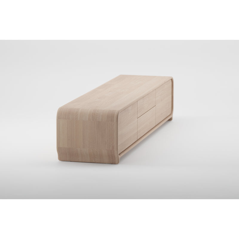 The Artisan ENY Lowboard is a versatile piece that serves as a minimalist wooden bench or table. Its sleek, rectangular design with rounded edges and flat top is crafted from solid wood with a light finish, using environmentally-friendly materials.