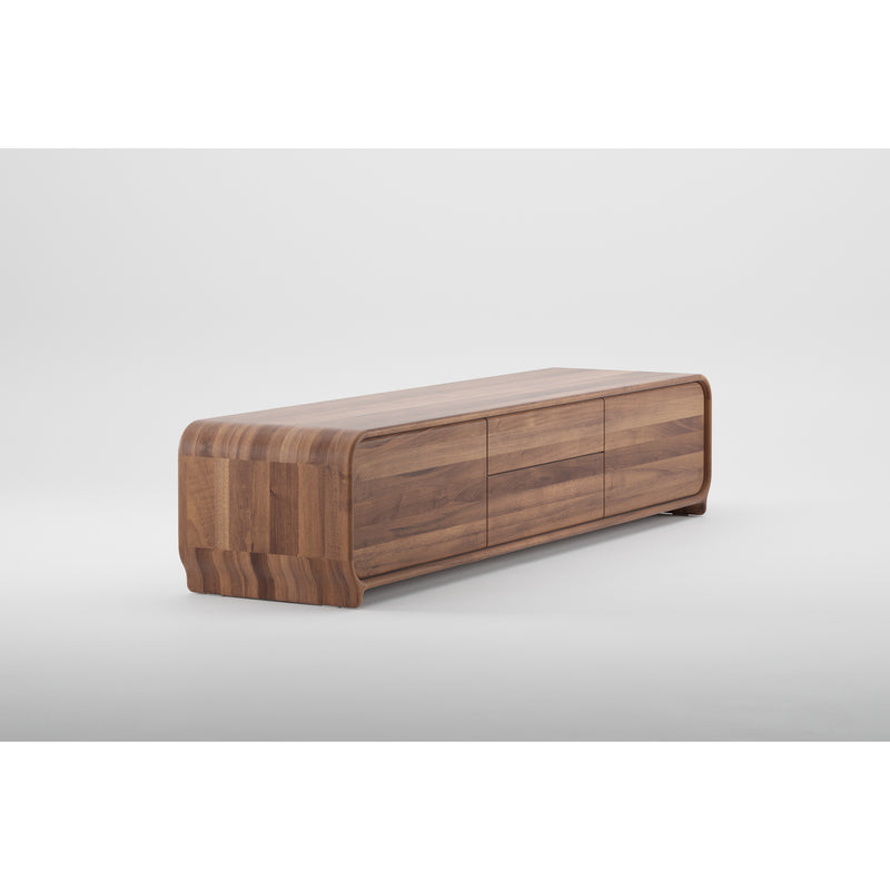 The Artisan ENY Lowboard is a solid wood sideboard with a sleek, curved design and three cabinet doors. Finished with natural oils against a minimal white backdrop, it highlights its natural wood grain and modern style, crafted from environmentally-friendly materials.