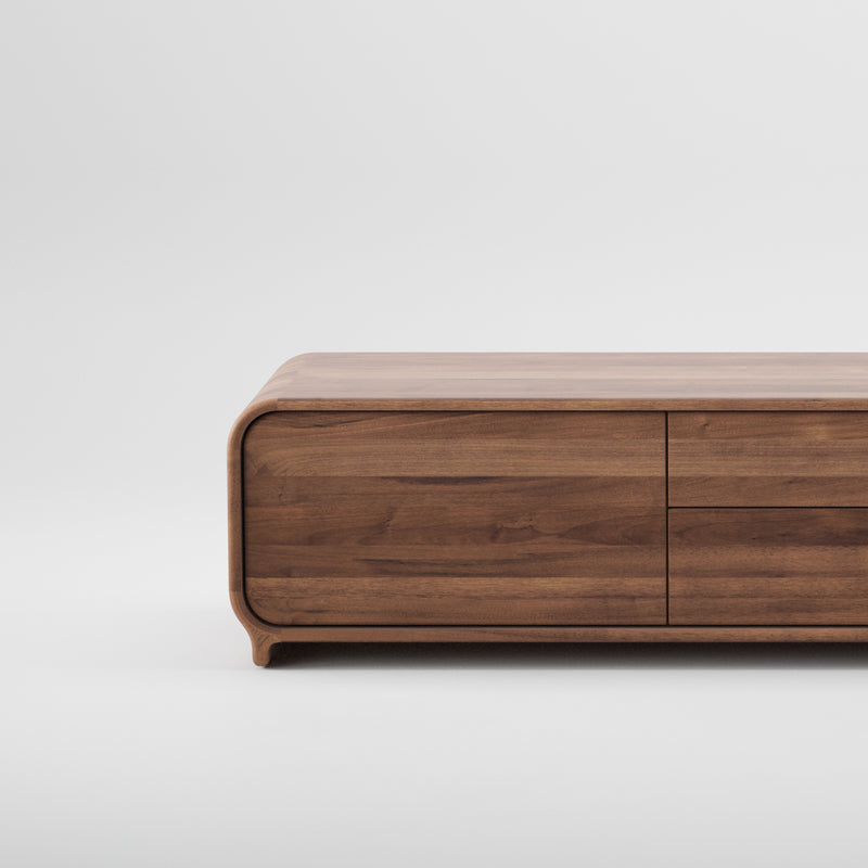 Crafted from solid wood, the ENY Lowboard by Artisan showcases a minimalist design with smooth, curved edges and visible horizontal wood grain lines against a plain white background, highlighting its elegance through eco-friendly materials.