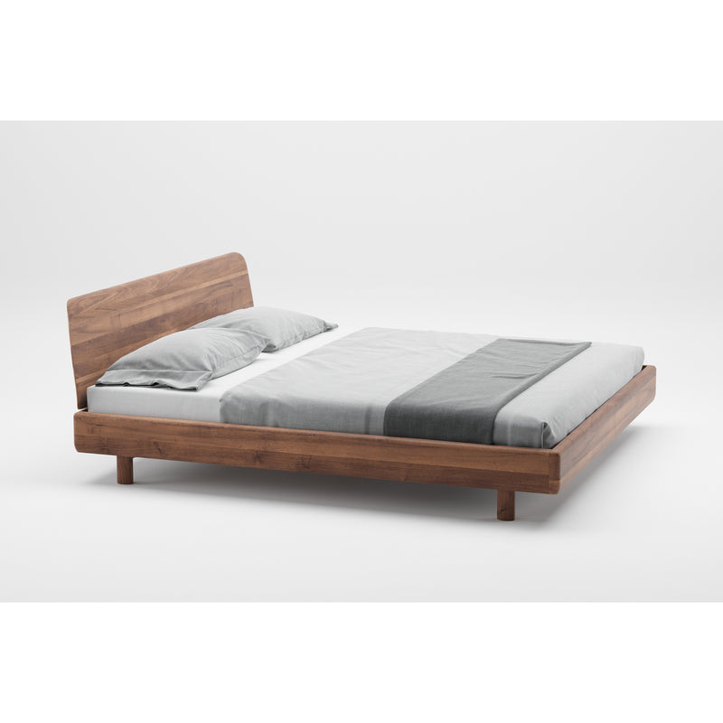 The FIN Bed by Artisan features a minimalist wooden design that highlights its natural texture. It includes a headboard and comes with a gray bedsheet and matching gray and white pillow, set against a plain white background.