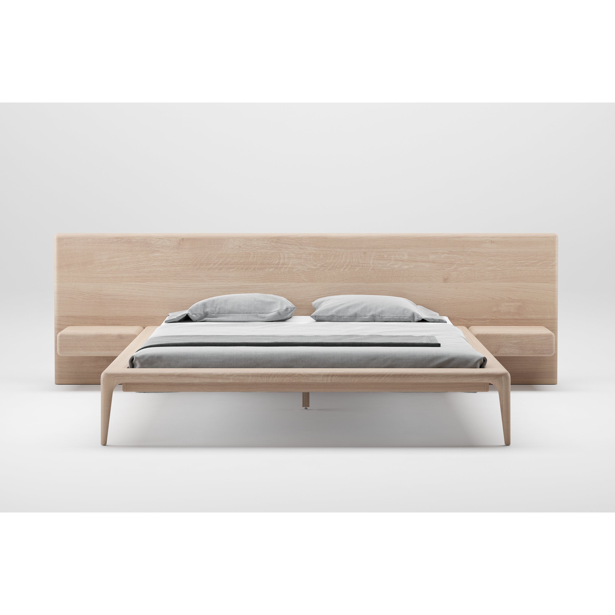 The Artisan LATUS Bed is a minimalist design crafted from solid wood, featuring a large headboard and integrated side tables. It includes gray and white bedding, boasts an eco-friendly natural finish, and stands out against a plain white background.