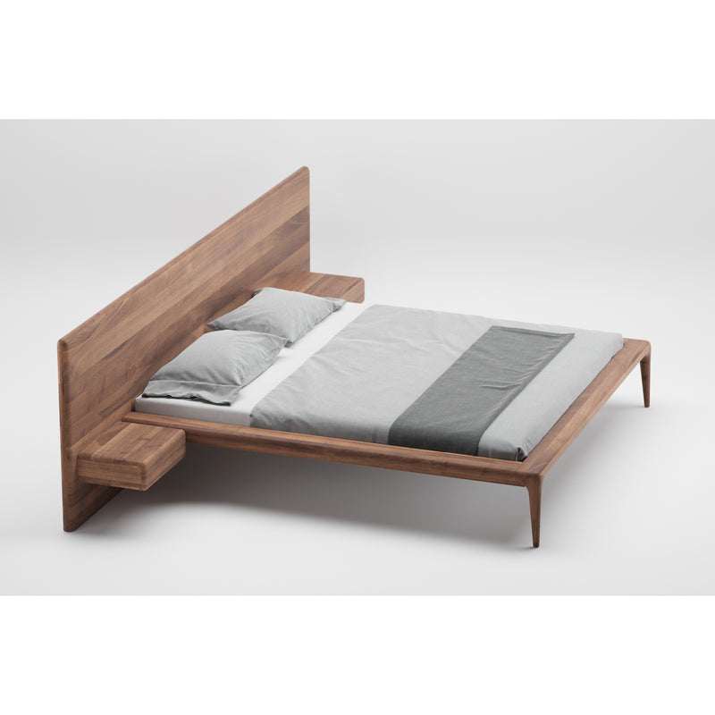 The LATUS Bed by Artisan is a minimalist solid wood design with built-in side tables and a large rectangular headboard. Crafted from eco-friendly materials, it features light gray bedding and two pillows, standing elegantly against a plain white background.