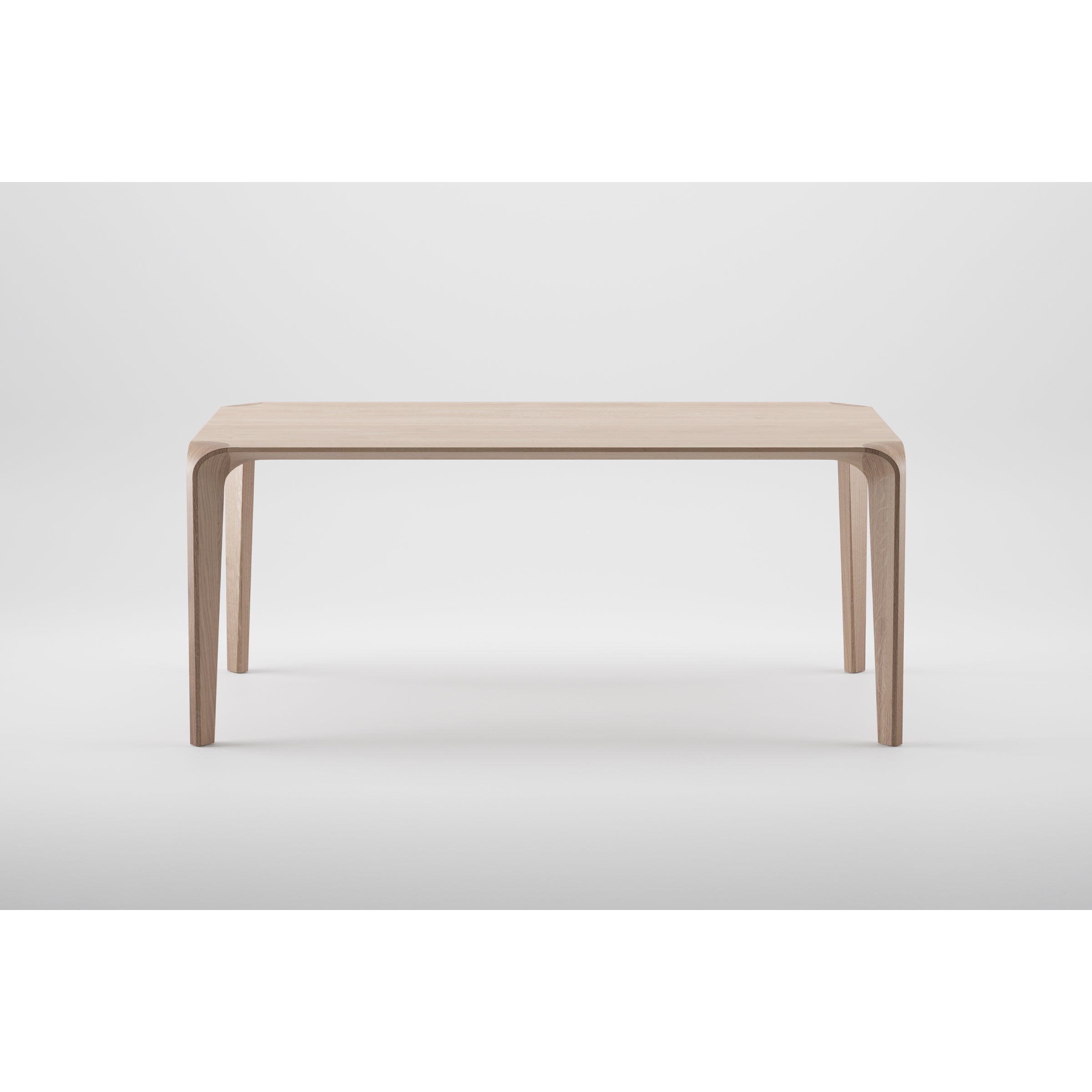 The Artisan FLOW Table is a minimalist wooden table crafted from solid wood with a natural oil finish, featuring sharp, clean lines and gracefully tapered legs. Its neutral white background enhances its modern, eco-friendly design.