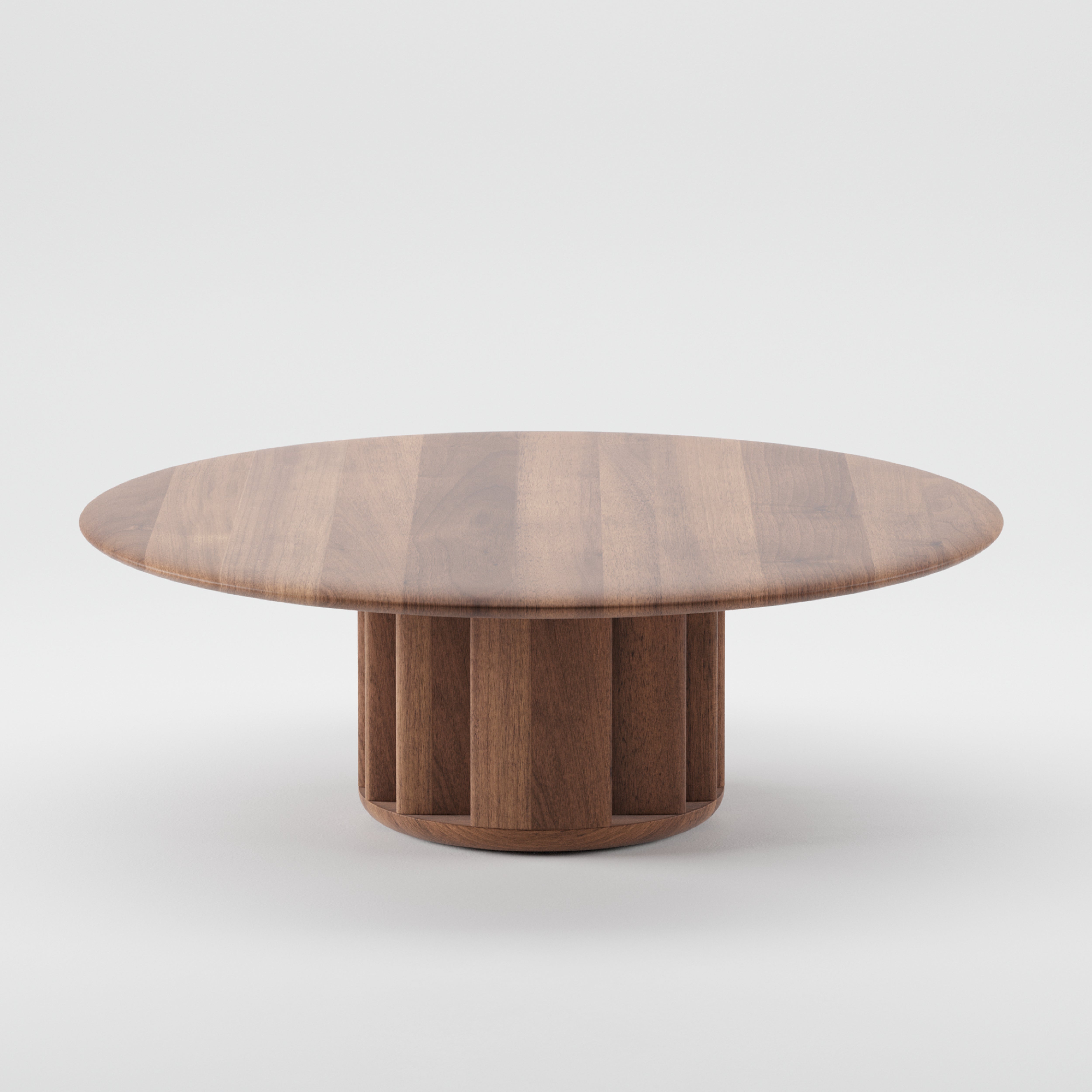 The GRID Coffee Table by Artisan is a round wooden piece with a smooth top and columnar base, crafted from sustainable materials. Its rich brown tone highlights natural grain patterns, featuring a minimalist design and eco-friendly finishes for a modern touch.