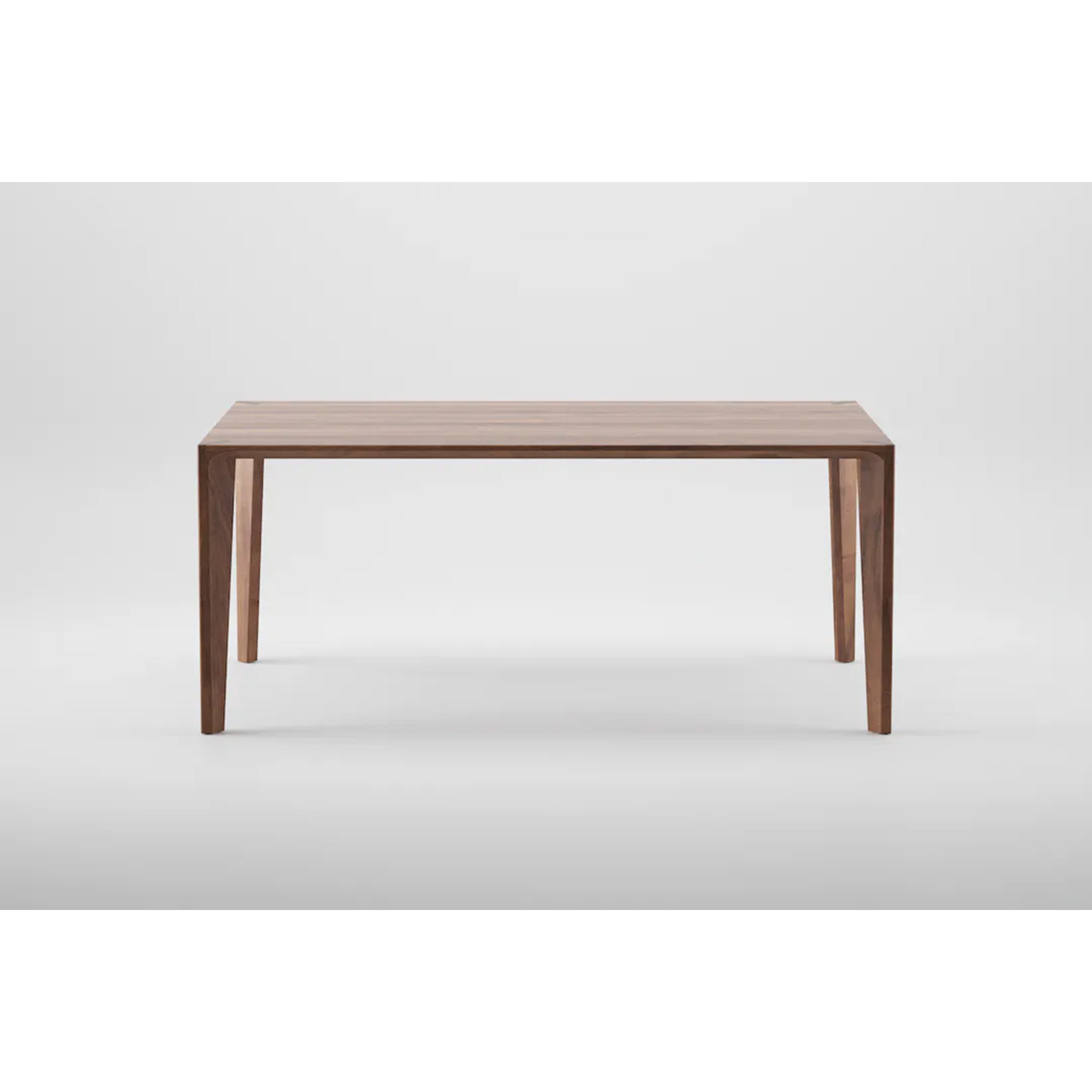 The Artisan HANNY Extension Table features a minimalist design with a rectangular top and four tapered legs. Crafted from eco-friendly materials, its clean lines and natural wood finish are accentuated against a plain white background.