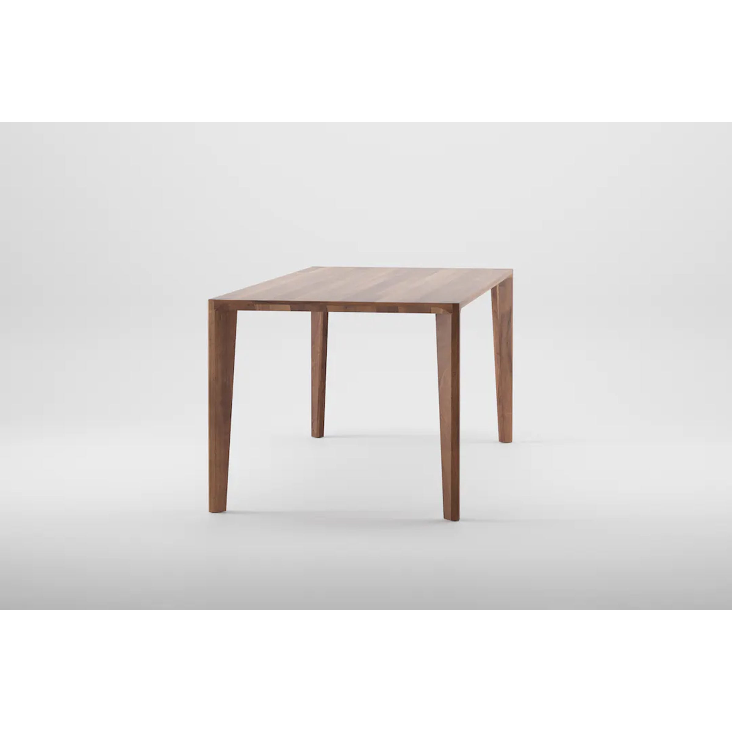 The Artisan HANNY Extension Table features a rectangular wooden top with four tapered legs against a white background, showcasing natural wood texture and eco-friendly materials in a simple, modern design. Crafted from solid wood furniture, it embodies elegance and sustainability.