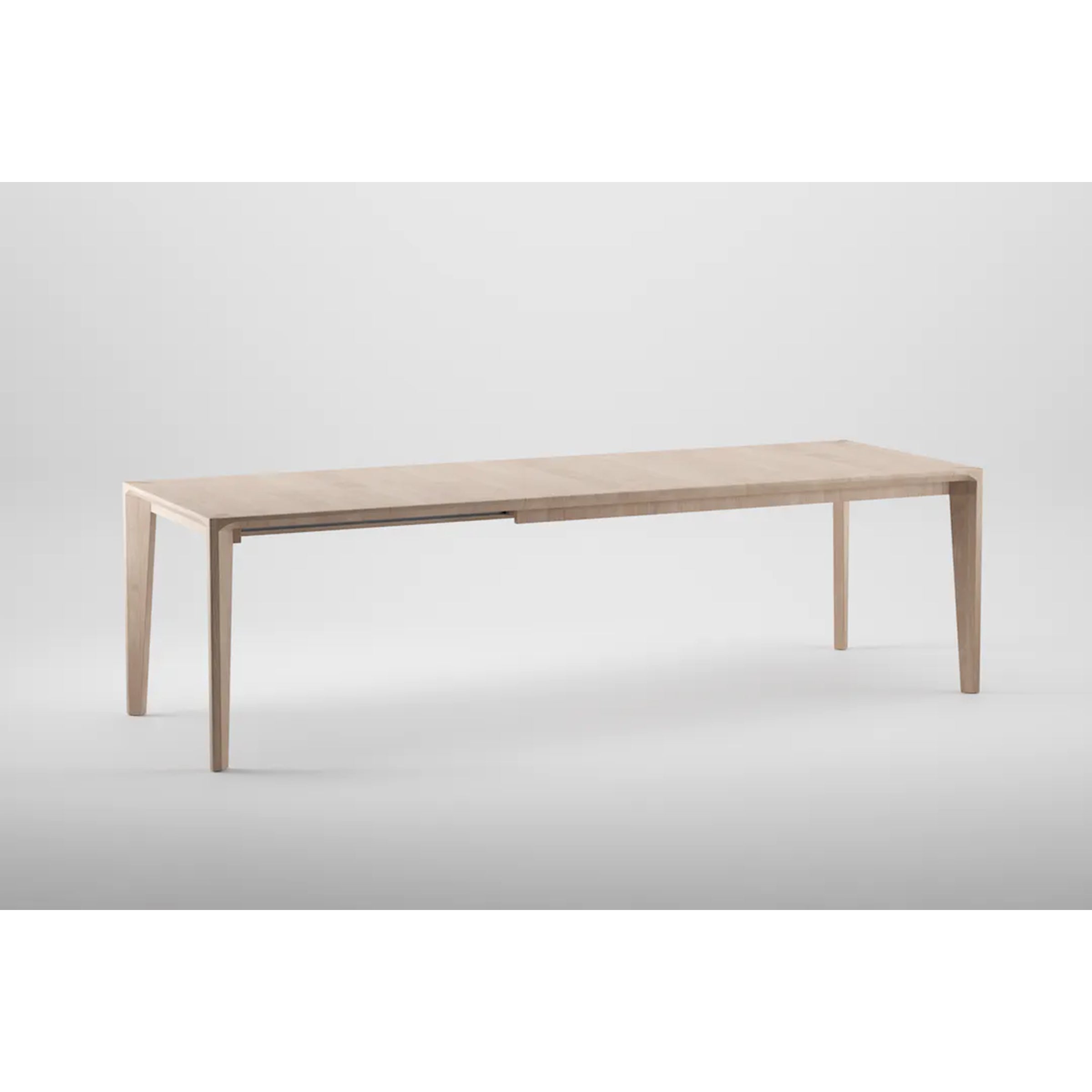 The HANNY Extension Table by Artisan is a minimalist wooden dining table crafted from eco-friendly materials, featuring a light natural finish with four slender legs, clean lines, and a rectangular shape against a plain white background.