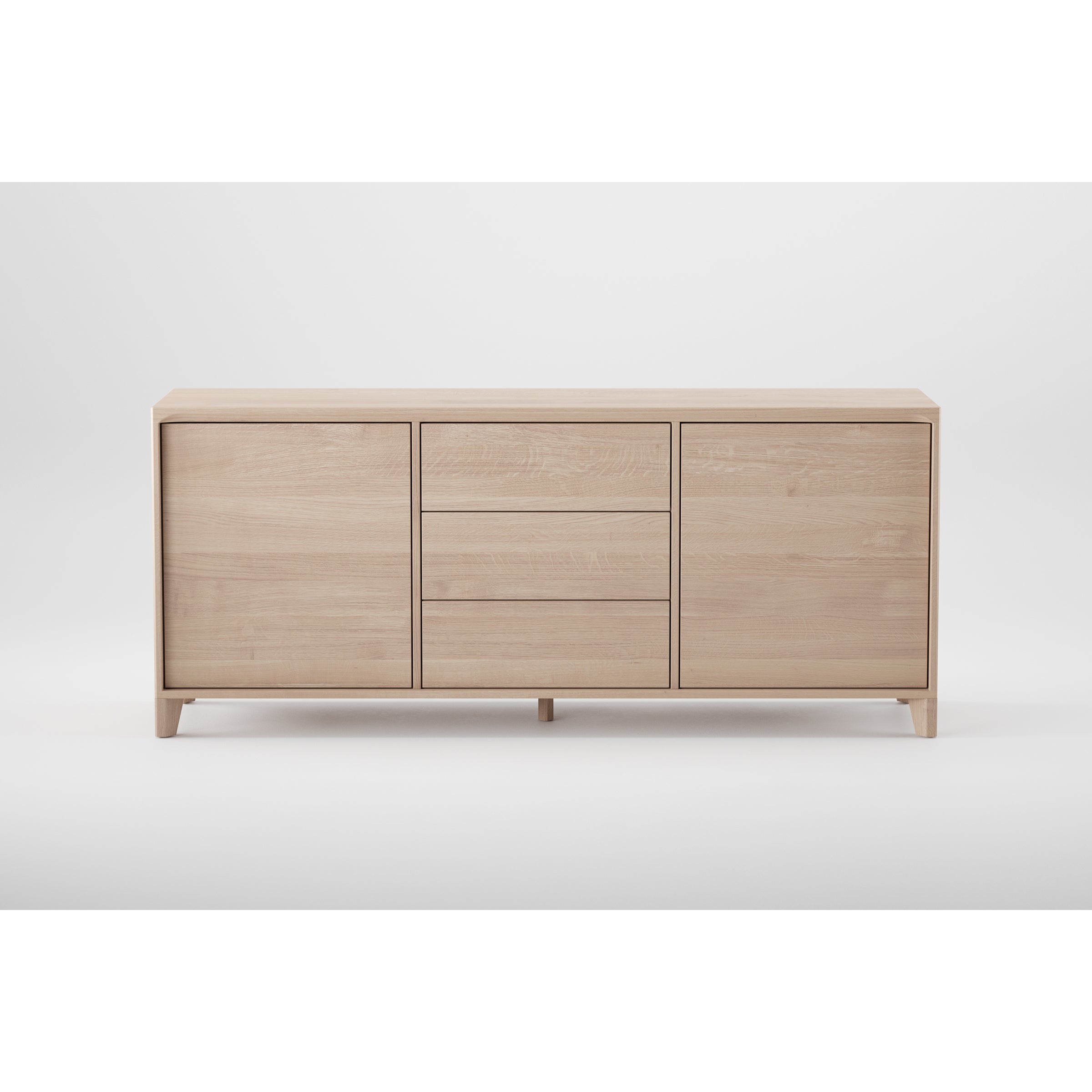The Artisan HANNY Sideboard is crafted from eco-friendly materials and features a minimalist design in light wood. It includes two cabinet doors on each side, three central drawers with subtle handles, all set against a plain white background.