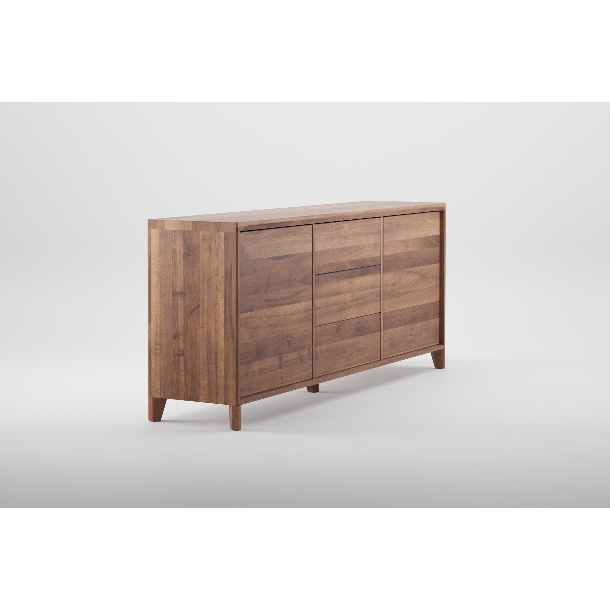 The Artisan HANNY Sideboard offers a minimalist wooden design with a smooth surface, three panel doors, and natural wood grain enhanced by oils and wax. It stands on short, angled legs.