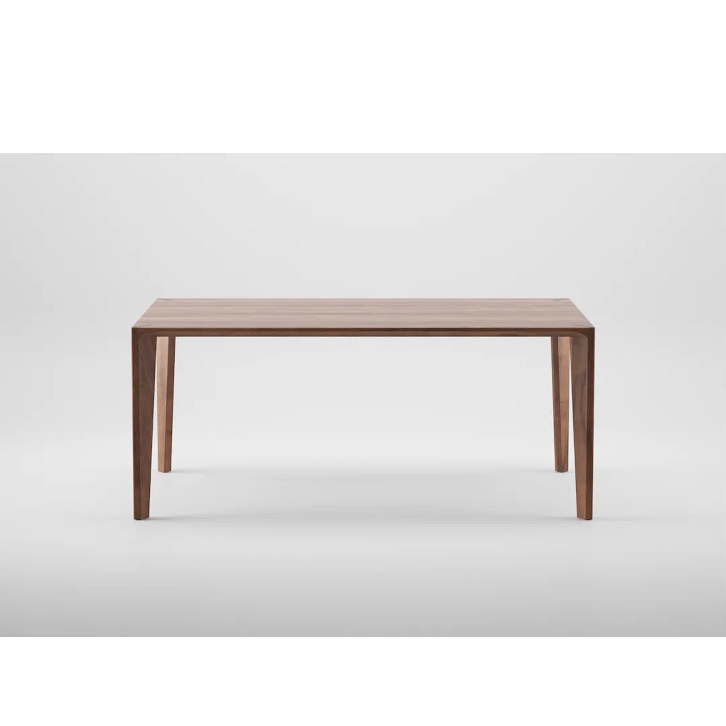 The HANNY Table by Artisan features a rectangular solid wood top with four sturdy legs on a plain white background. Its minimalist design highlights the natural wood grain, crafted using eco-friendly materials.
