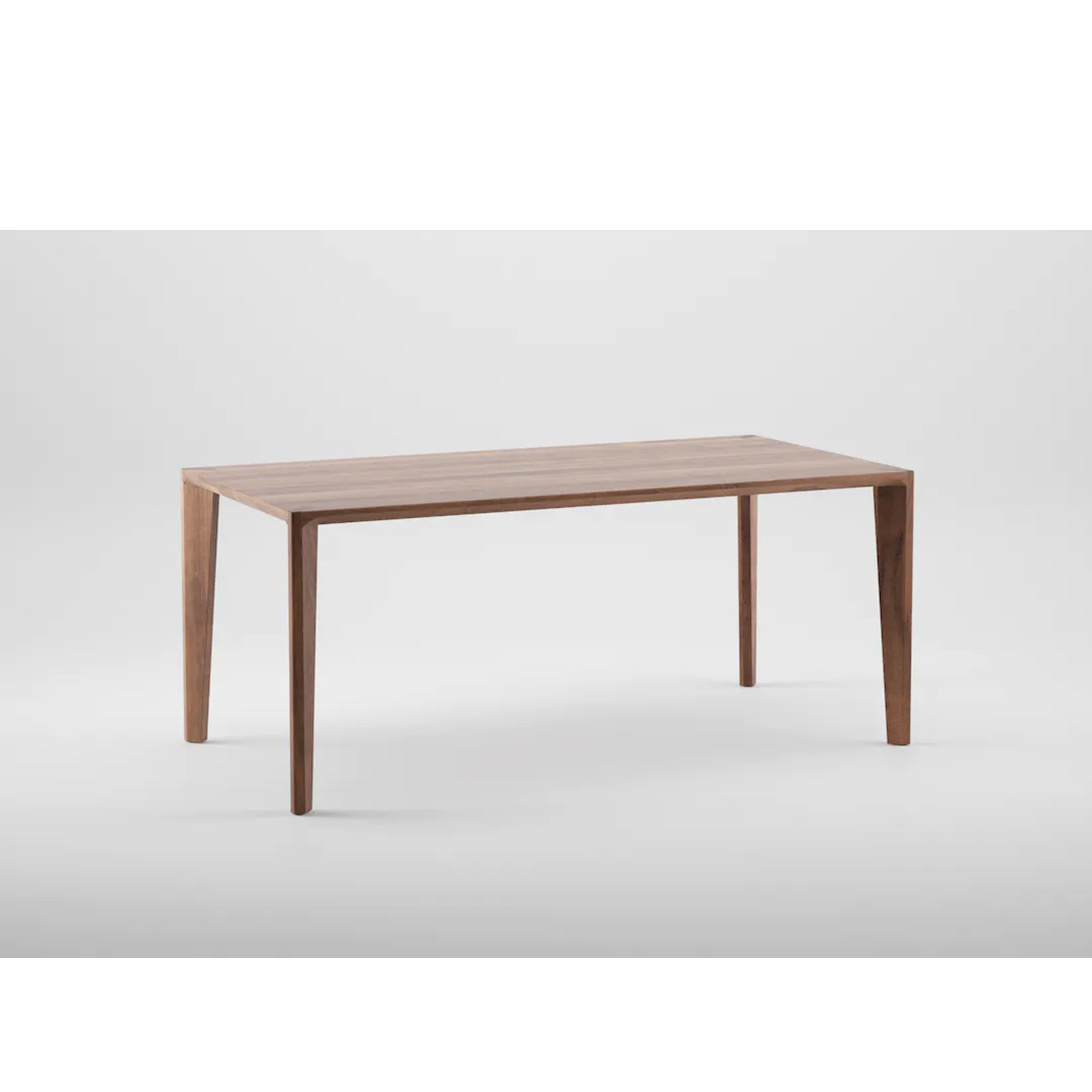 The HANNY Table by Artisan is a minimalist piece featuring a smooth, rectangular top and four tapered legs. Crafted from solid wood with natural oils and wax, it showcases clean lines and an eco-friendly design against a plain white background.