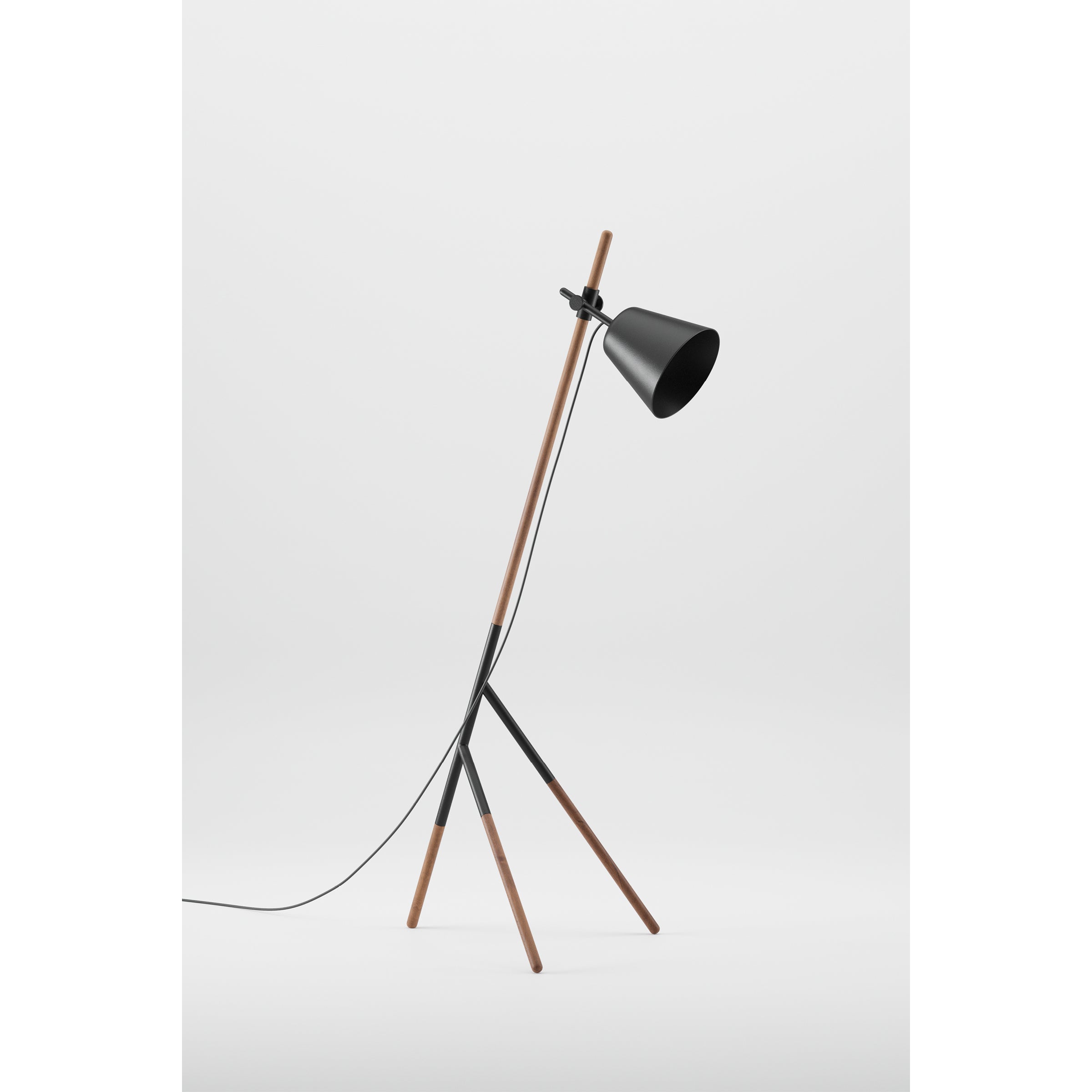 The Artisan INSERT Floor Lamp features three solid wood tripod legs and a sleek black adjustable shade, all crafted from eco-friendly materials. It includes a power cord and stands out against the plain white background with its minimalist design.