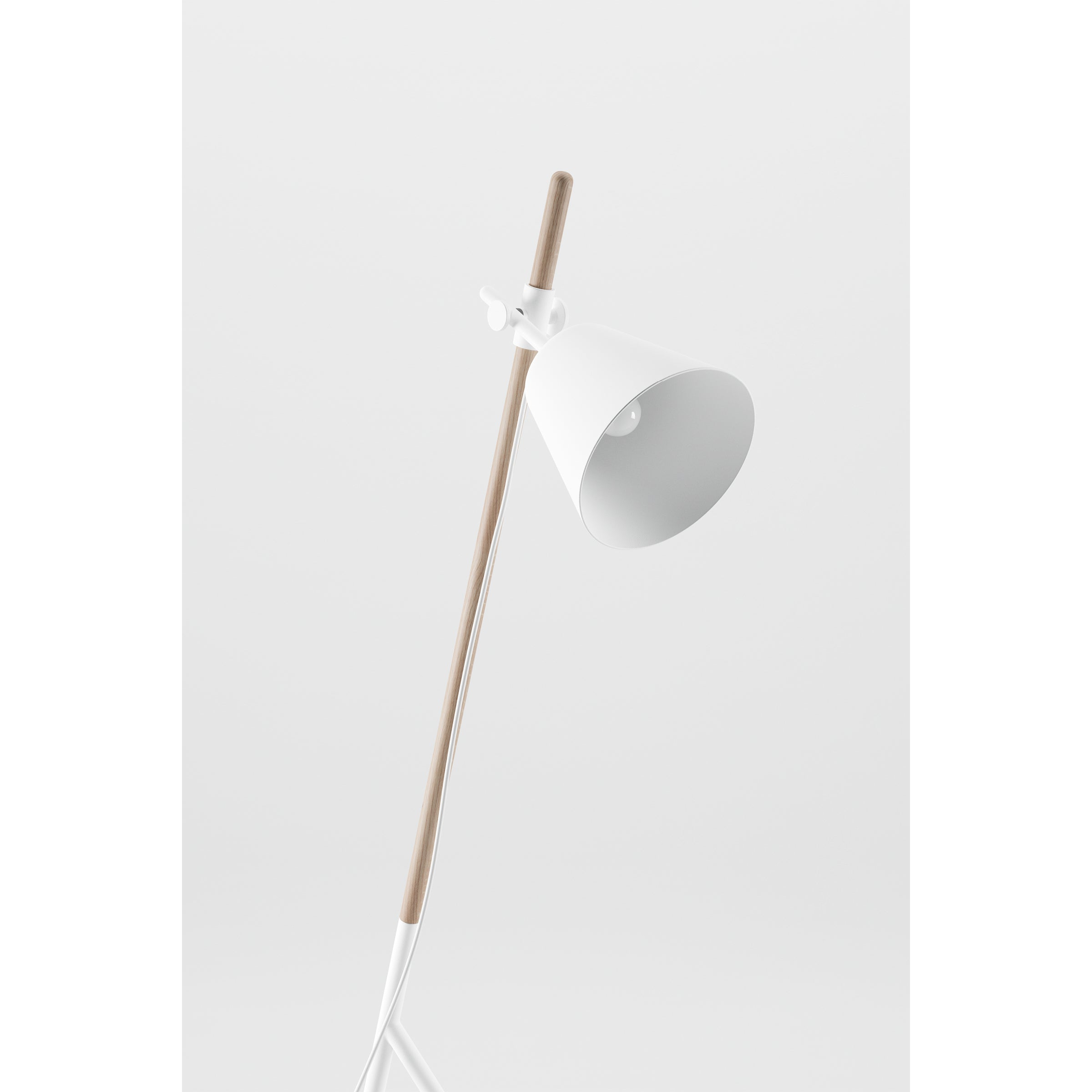 The Artisan INSERT Floor Lamp, made from solid wood with a white cone-shaped shade and finished with natural oils, stands slightly angled against a plain white backdrop, showcasing its eco-conscious elegance.