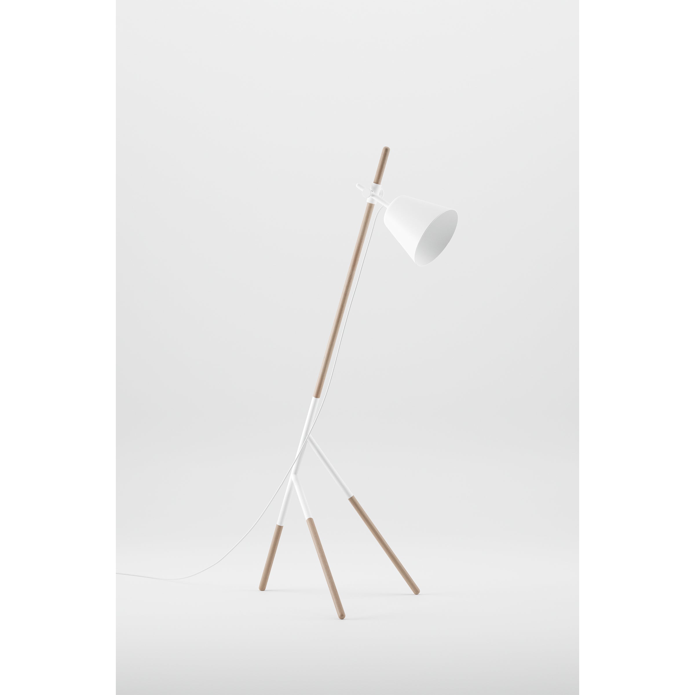 The Artisan INSERT Floor Lamp is a modern design with a minimalist white conical shade and solid wood tripod legs. Made from eco-friendly materials, its clean lines and neutral tones offer a contemporary feel.