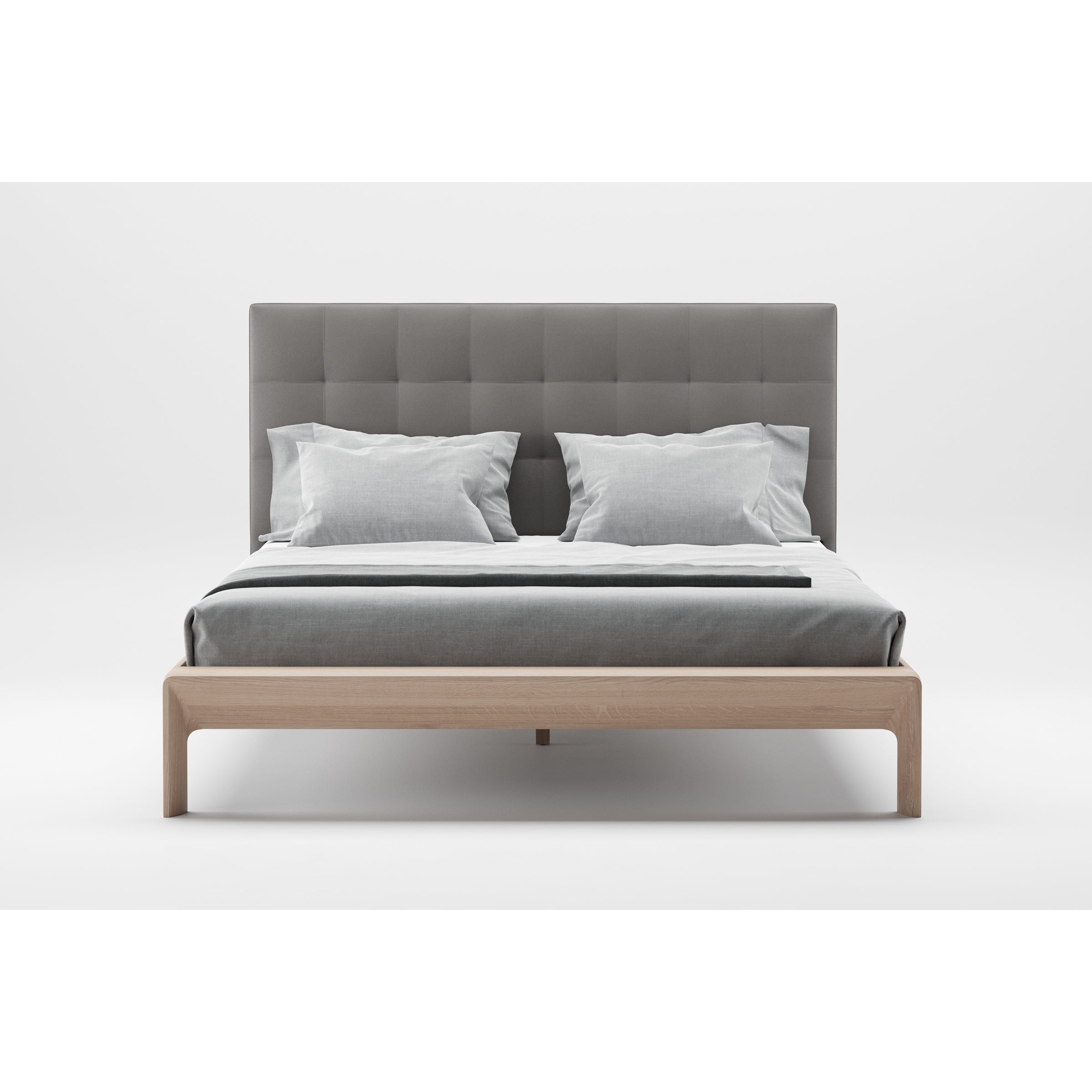The INVITO Bed by Artisan features a modern light wooden frame with a tall, tufted grey headboard, complemented by light grey bedding and pillows. Its stylish design emphasizes natural wood texture against a white backdrop for a clean, minimalist look.