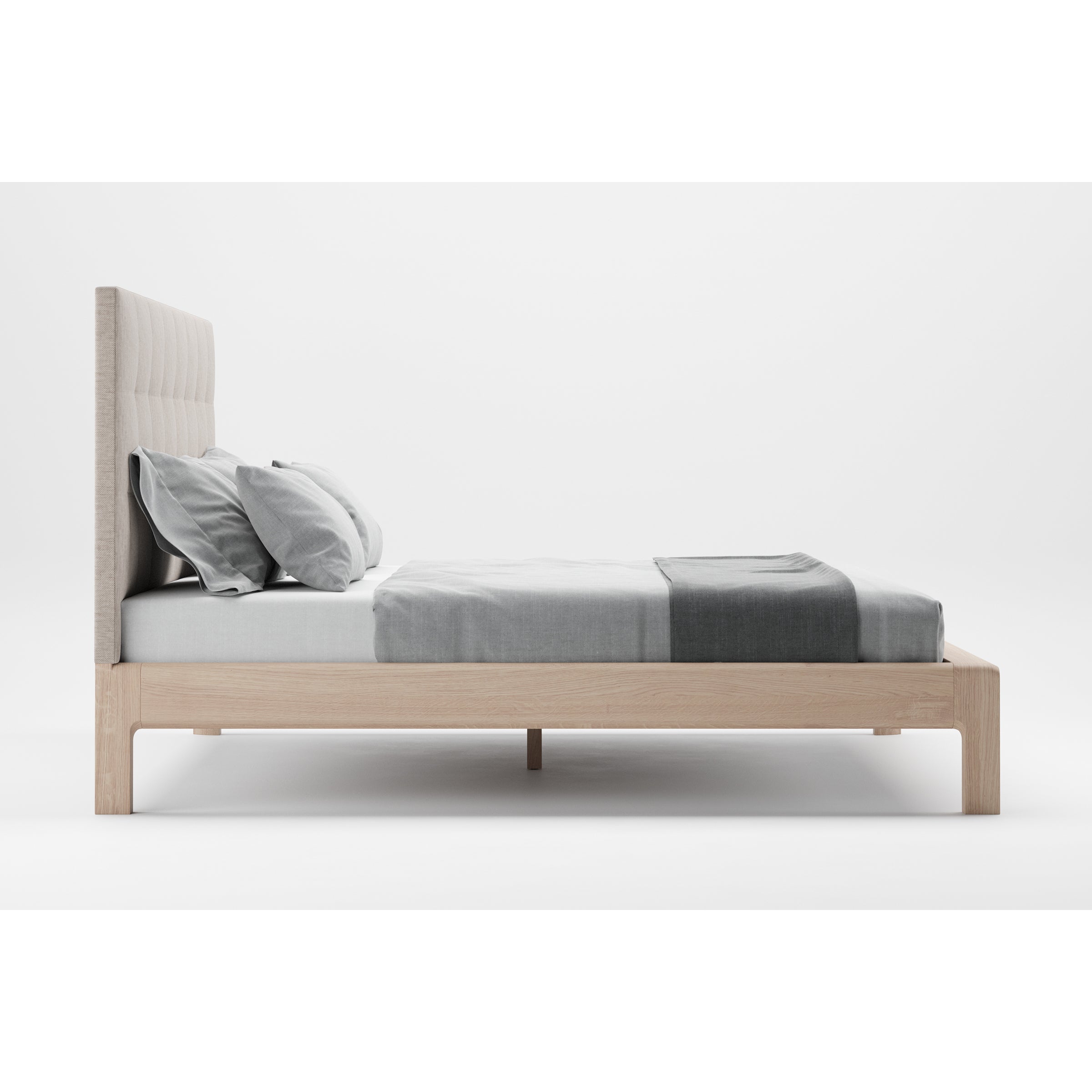 Minimalist bedroom setup with the INVITO Bed by Artisan, boasting a light wooden frame that highlights its natural texture. The padded headboard pairs elegantly with a white and gray duvet and pillows, all set against an elegant white background.