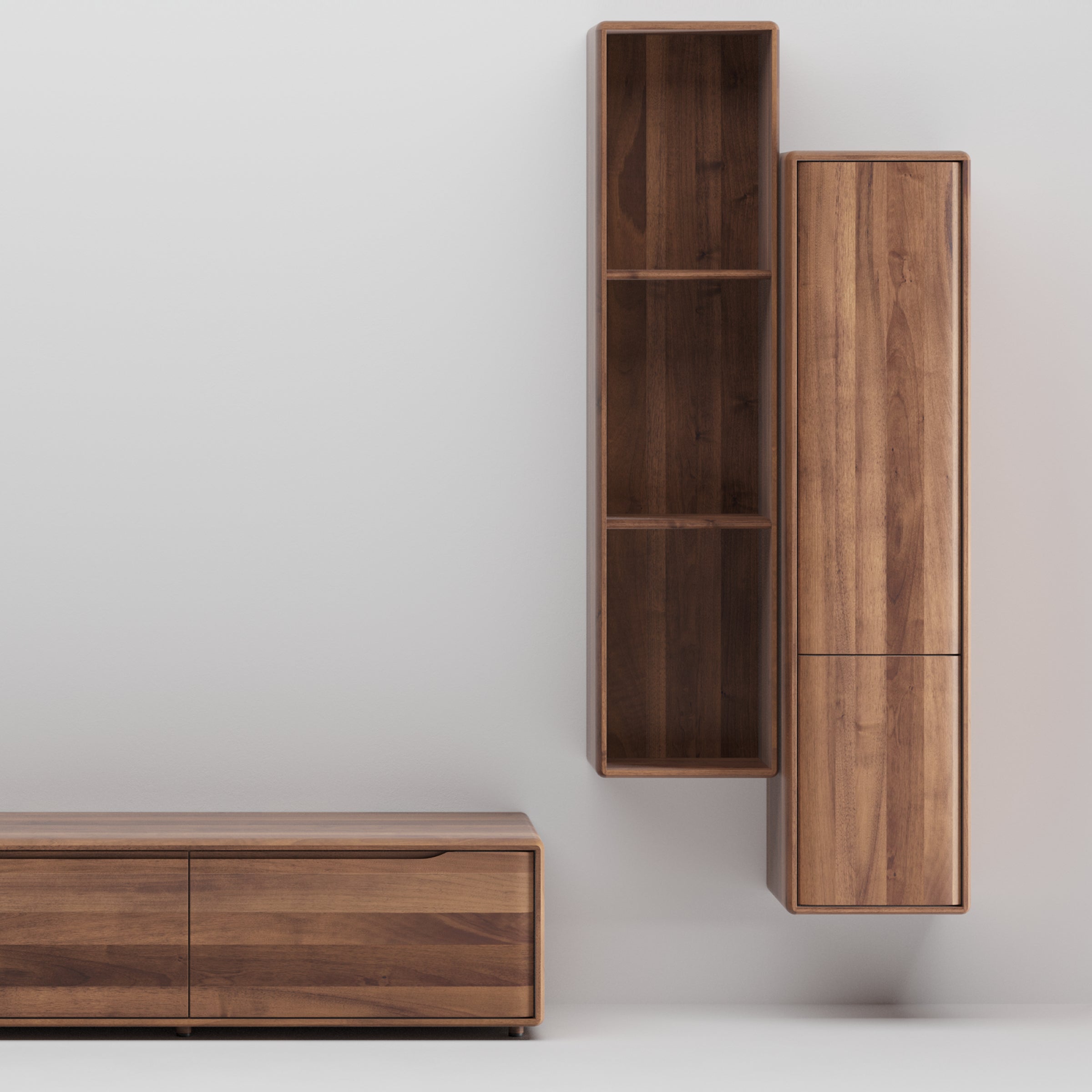 The Artisan INVITO MS Wall Modules, crafted from solid, eco-friendly materials, feature a minimalist design with a low cabinet having two left-side doors and a tall, two-section wall-mounted shelving unit on the right against a white background, all boasting a rich natural wood finish.