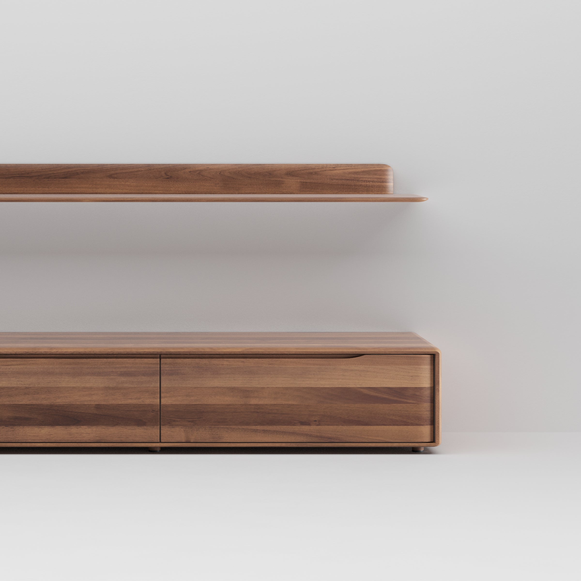 The image showcases Artisans INVITO MS Wall Modules: a minimalist wooden shelf and cabinet made of solid wood against a plain light wall. With clean lines, smooth surfaces, and visible natural wood grain, it embodies contemporary style using environmentally-friendly materials.