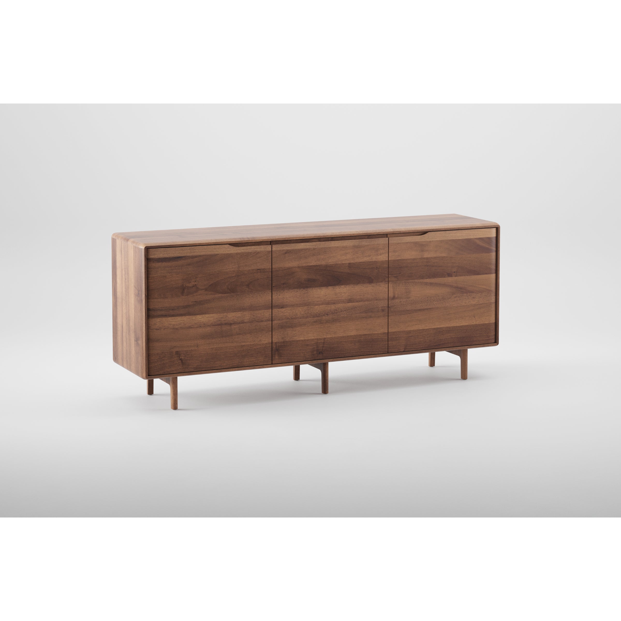 The INVITO Sideboard by Artisan is a mid-century modern piece crafted from solid wood with natural oils. Its sleek, minimalist design includes three closed compartments, smooth lines, and short legs, all set against a plain white background.