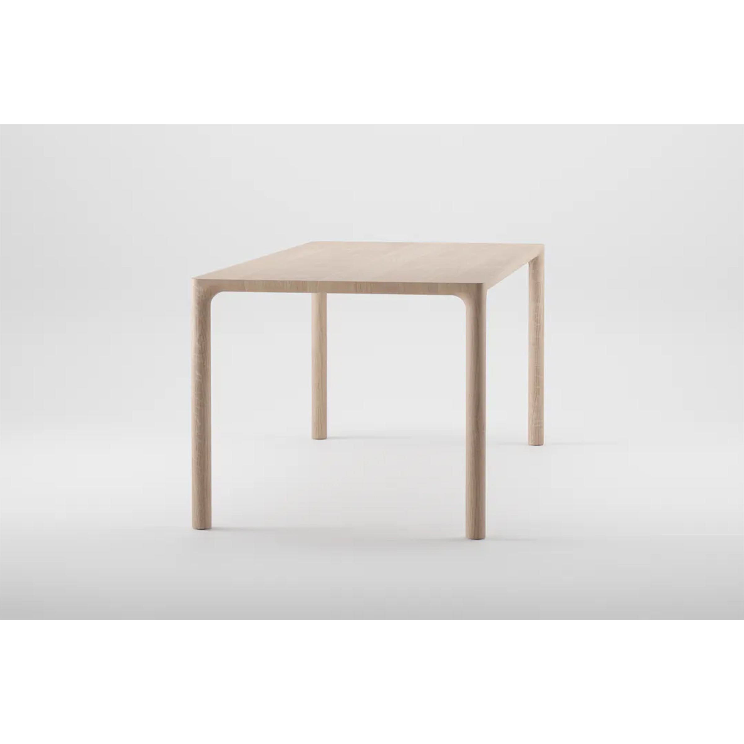 The Artisan JEAN Table exemplifies minimalist design with its solid wood construction, featuring clean lines, a light finish, a rectangular top, and slender rounded legs against a plain white background.