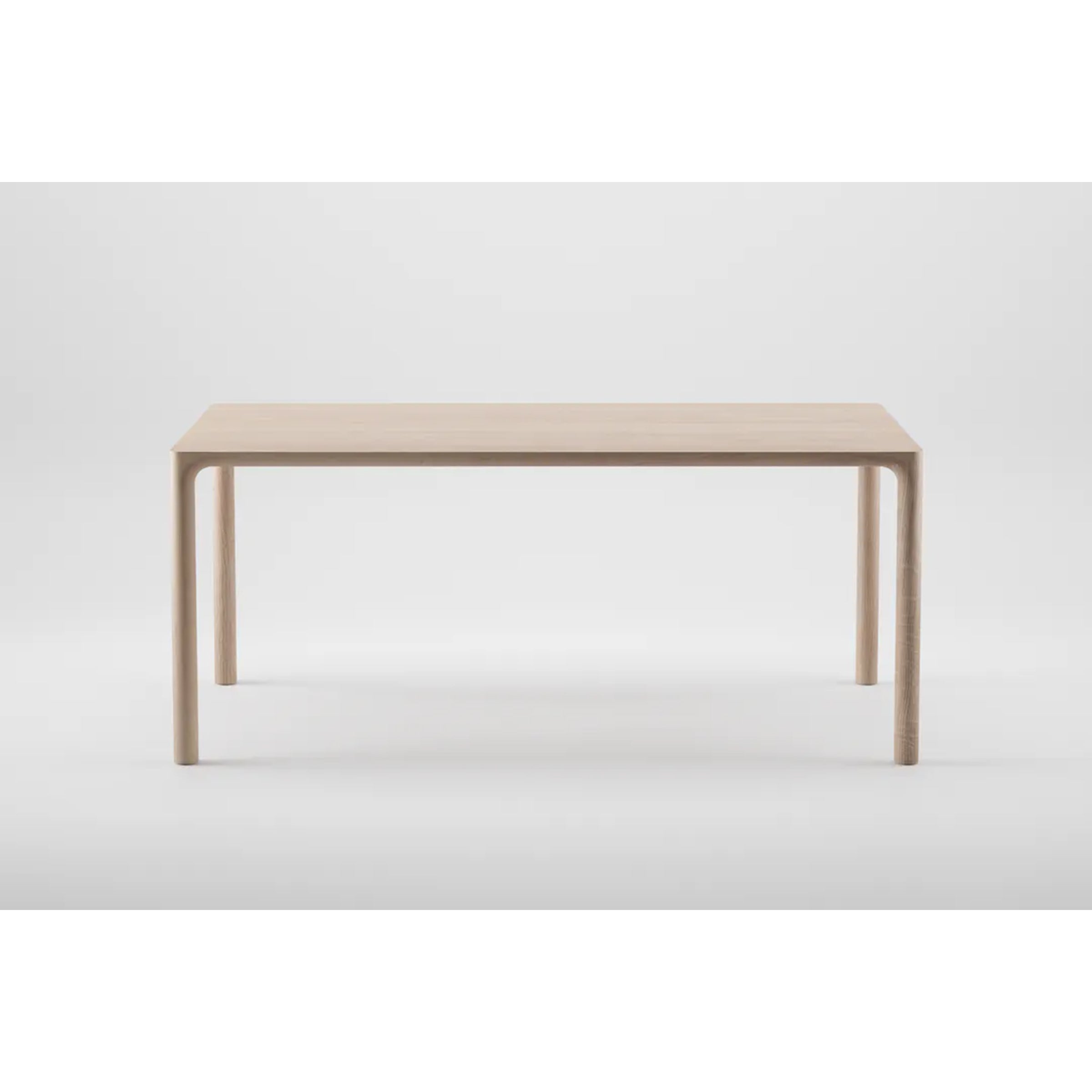 The JEAN Table by Artisan is a minimalist piece featuring a solid wood construction with a rectangular top and sleek, simple legs, showcasing exquisite craftsmanship against a light gray background.