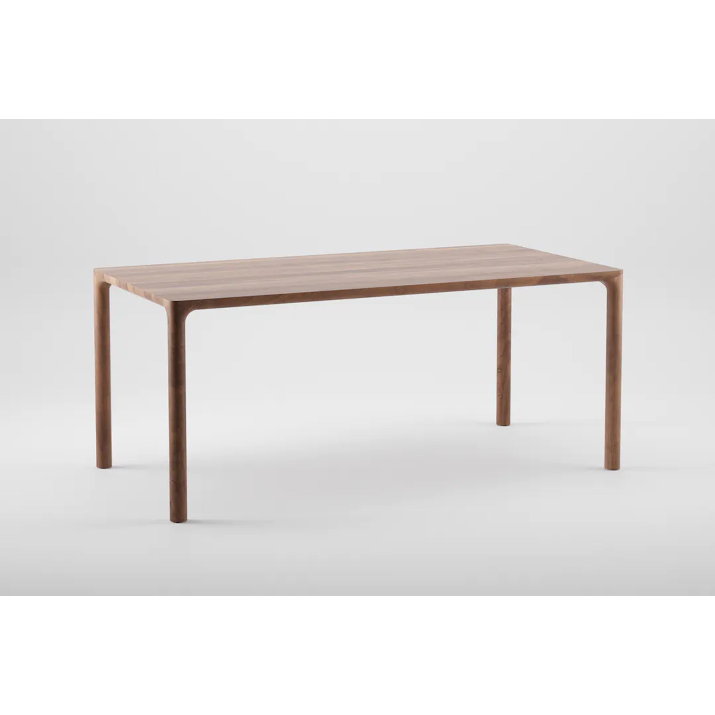 The JEAN Table by Artisan is a minimalist, rectangular solid wood piece with a smooth finish and four slightly curved legs, exhibiting exquisite craftsmanship against a plain white background.