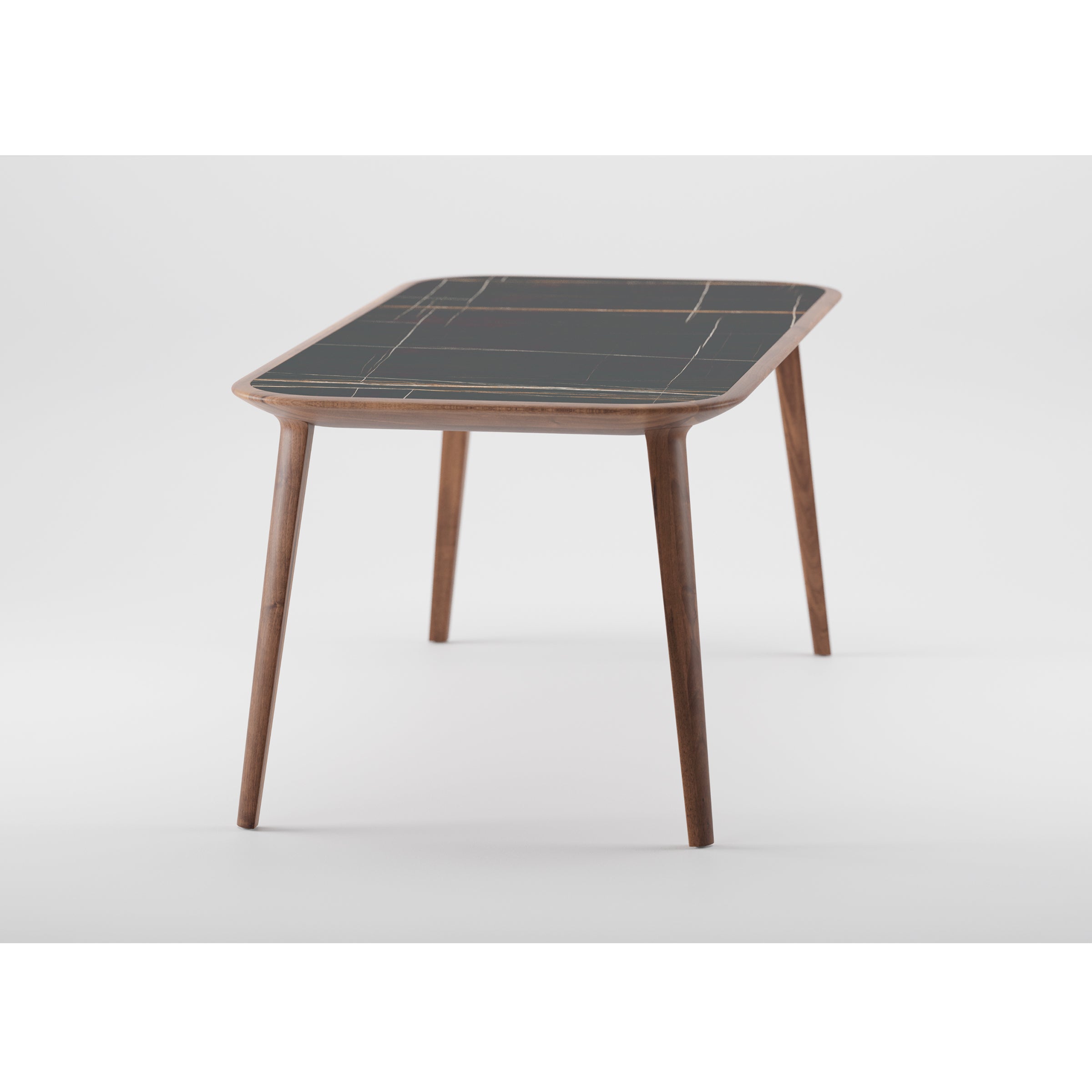 The Artisan KALOTA Table, featuring a green grid-patterned top and four tapered legs, showcases its solid wood construction with environmentally-friendly materials against a white background.