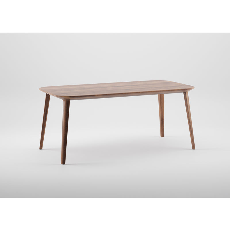 The KALOTA Table by Artisan features a minimalist design crafted from solid wood, with a rectangular top and four tapered legs. Finished with natural oils, it is set against a plain white background, showcasing the elegance of environmentally-friendly materials.