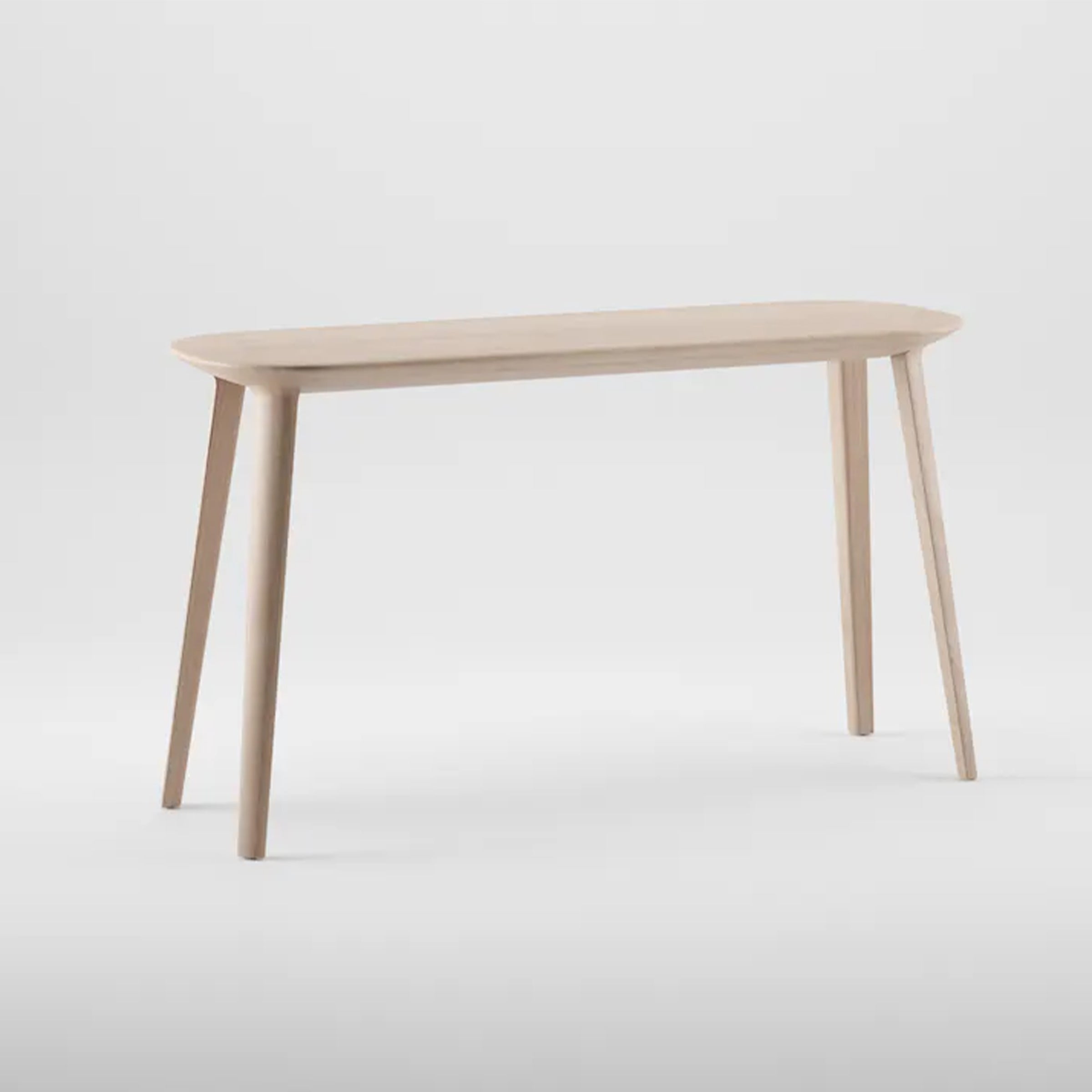 The KALOTA Console Table by Artisan features a light finish that highlights the wood texture. It has four tapered legs, a sleek rectangular surface with rounded edges, and is crafted from eco-friendly materials set against a light gray backdrop.