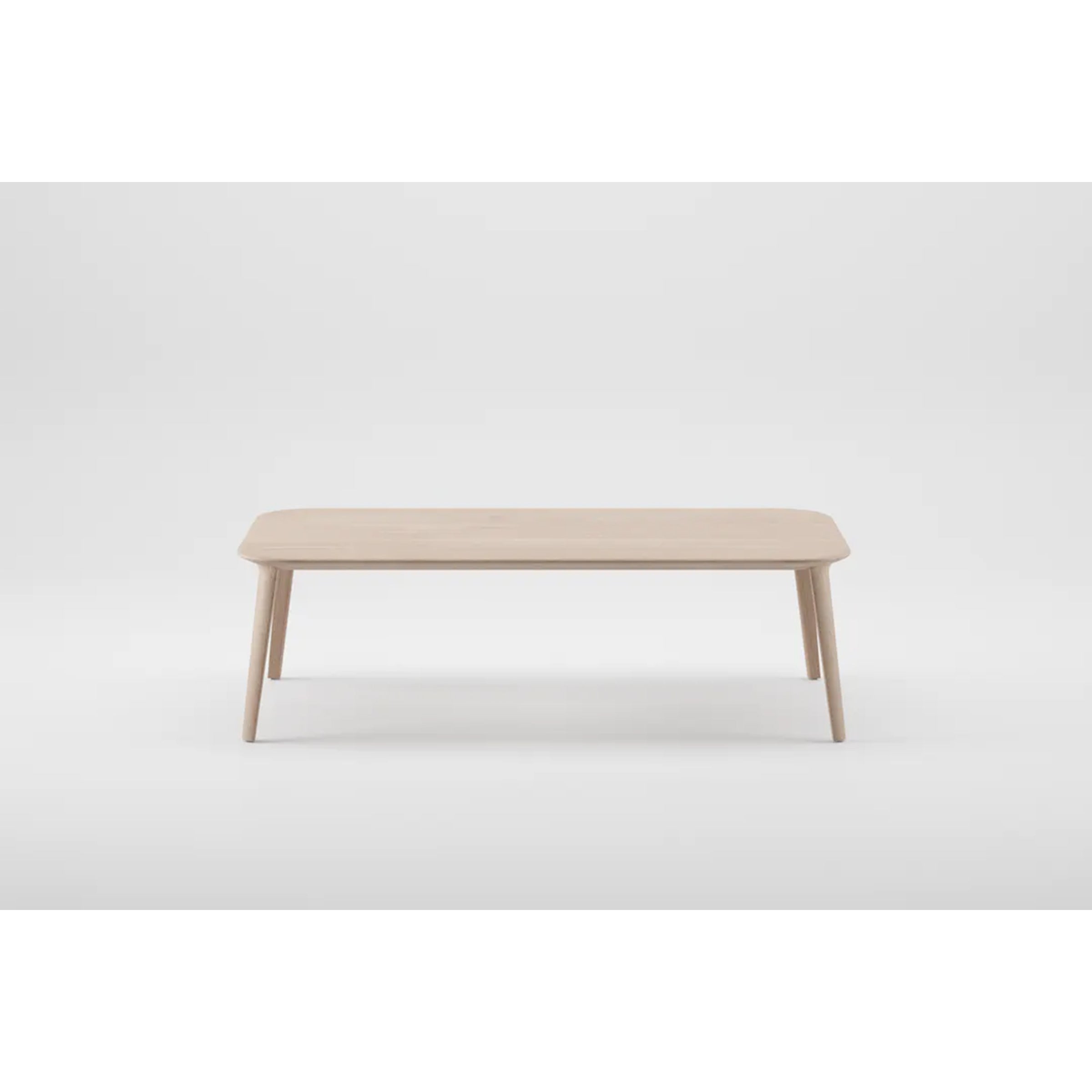 The KALOTA Coffee Table by Artisan is a minimalist piece crafted from solid wood with a light finish, featuring a rectangular top and four tapered legs. Made with eco-friendly materials and natural oils, it stands elegantly against a plain white background.