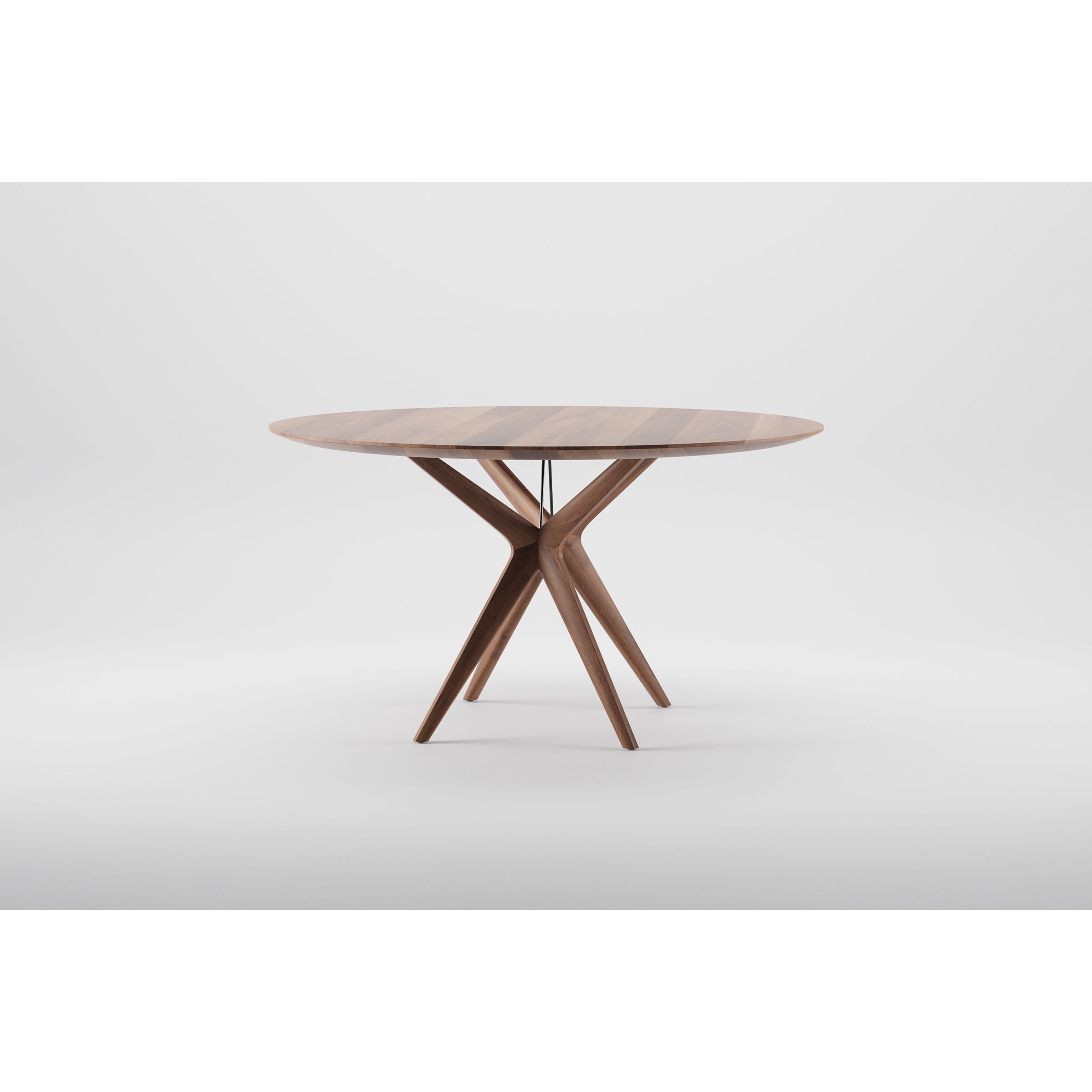 The LAKRI Round Table by Artisan is a round wooden piece with a smooth surface and distinctive tripod base featuring elegantly curved legs, refined with natural oils. Set against a plain white background, it exemplifies the use of environmentally-friendly materials.