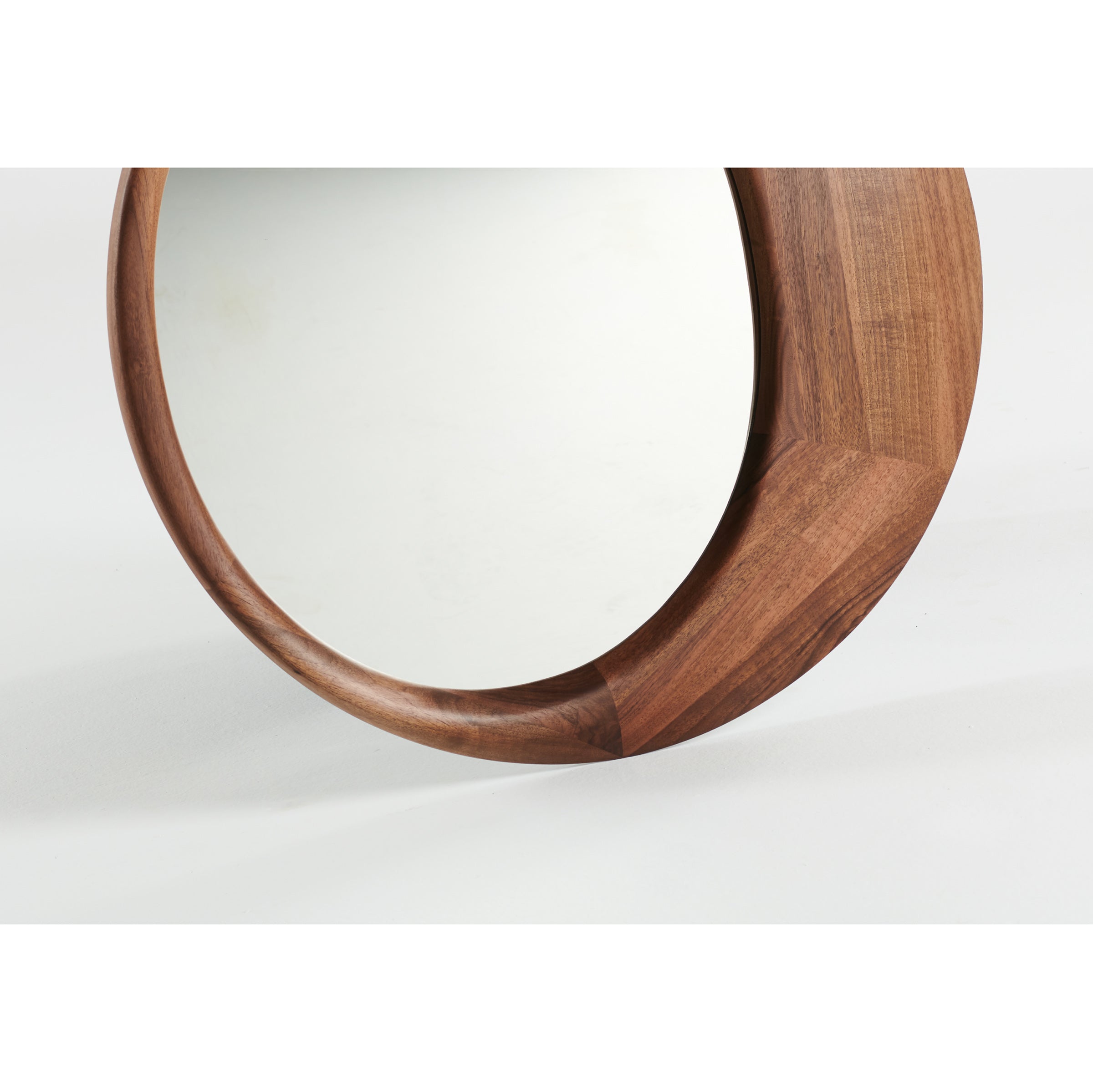 The Lana Mirror by Artisan is a round mirror with a solid wood frame, featuring a glossy light brown finish and smooth edges. Positioned against a plain white background, its sleek, minimalist design is enhanced by eco-friendly materials for an elegant appearance.