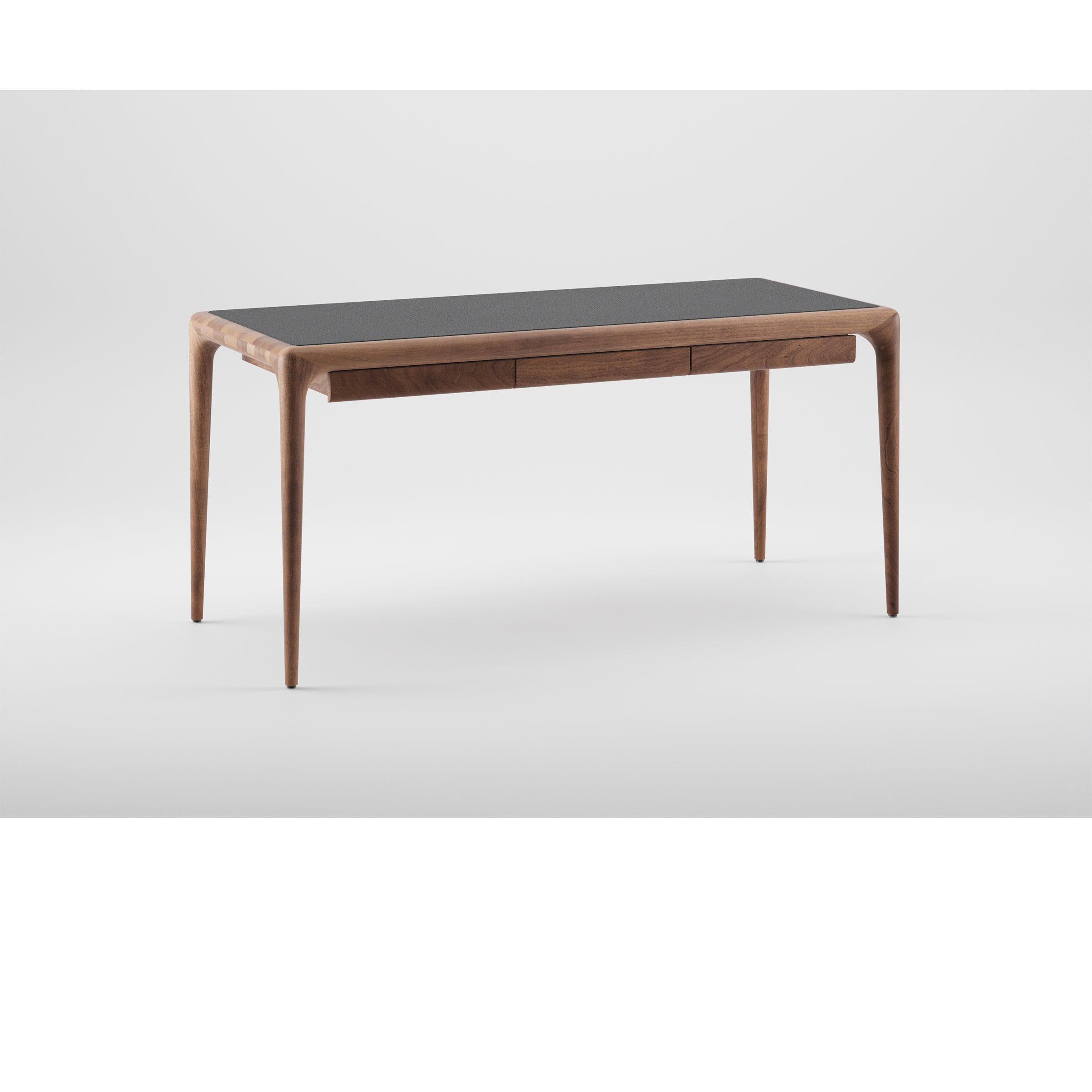 The LATUS Leather Desk by Artisan features a sleek wooden design with slender legs and a dark tabletop made from solid wood, finished with natural oils. It has two seamlessly integrated slim drawers and is showcased against a plain white background.