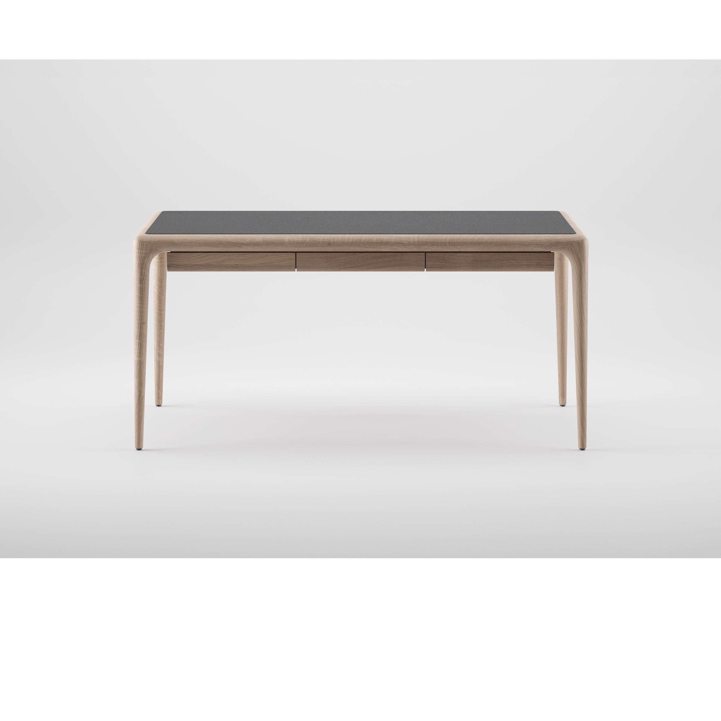 The Artisan LATUS Leather Desk features a sleek, minimalist design with slender legs and a black leather tabletop. Crafted from solid wood with two narrow drawers, it combines elegance and sustainability on a clean white backdrop using eco-friendly materials.