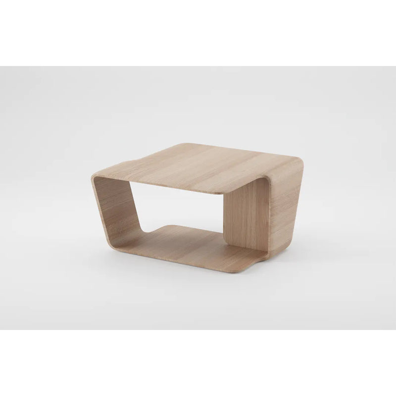 The Mars Coffee Table by Artisan is a minimalist side table crafted from solid wood with a curved design and open rectangular shape. It features a top surface and matching base connected by sides, finished with natural oils for eco-friendliness, set against a plain white background.