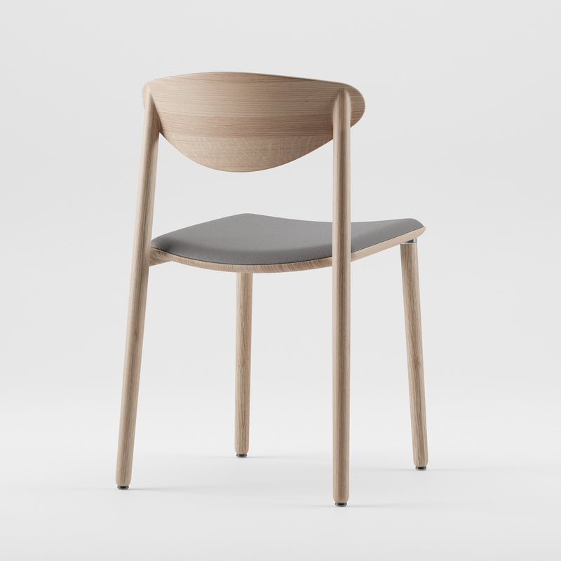 The NARU Chair Light by Artisan is a minimalist, eco-friendly modern chair featuring a light wood frame and a gray cushioned seat. Its design includes a curved backrest, four straight legs, and its shot against a plain white background.