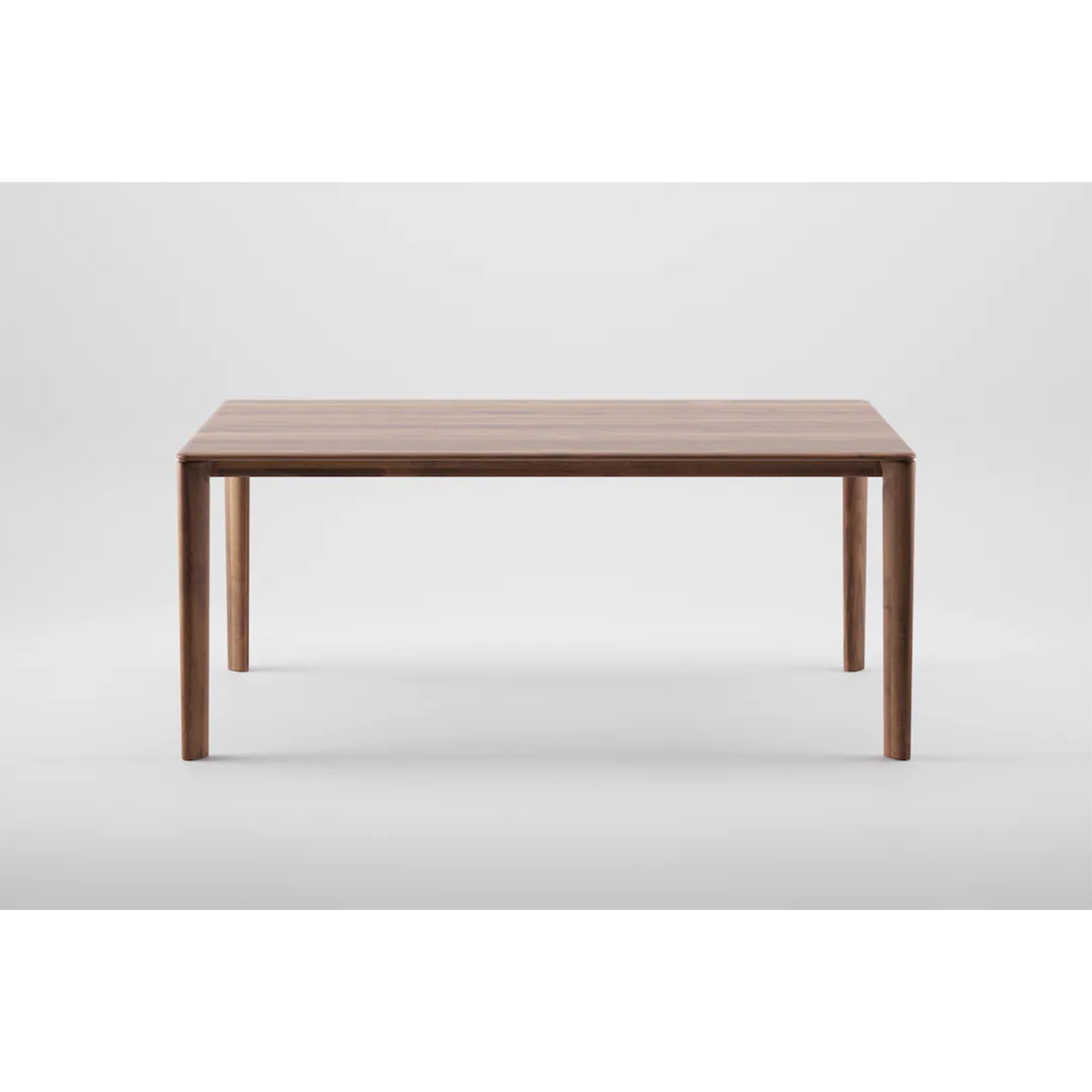 The NEVA Table Extendable by Artisan is a minimalist dining piece made from natural wood, featuring a rectangular top and four straight legs, set against a plain gray backdrop.