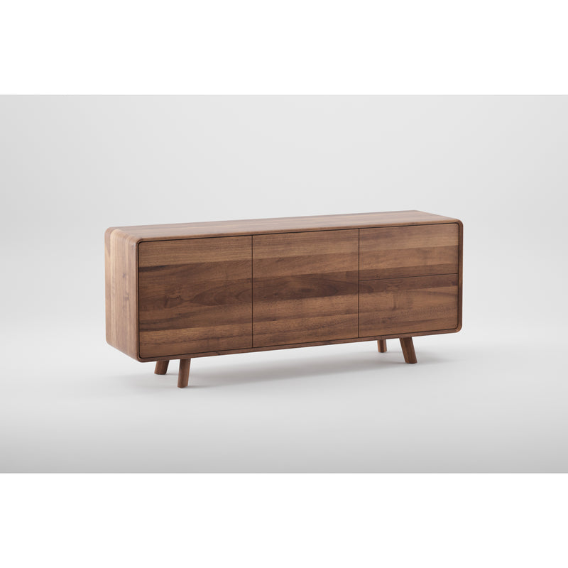 The NEVA Sideboard by Artisan is a modern wooden piece featuring artisanal craftsmanship with three doors and four angled legs. Its smooth, natural finish and minimalist design create a contemporary look, with rich brown wood contrasting beautifully against a plain white background.