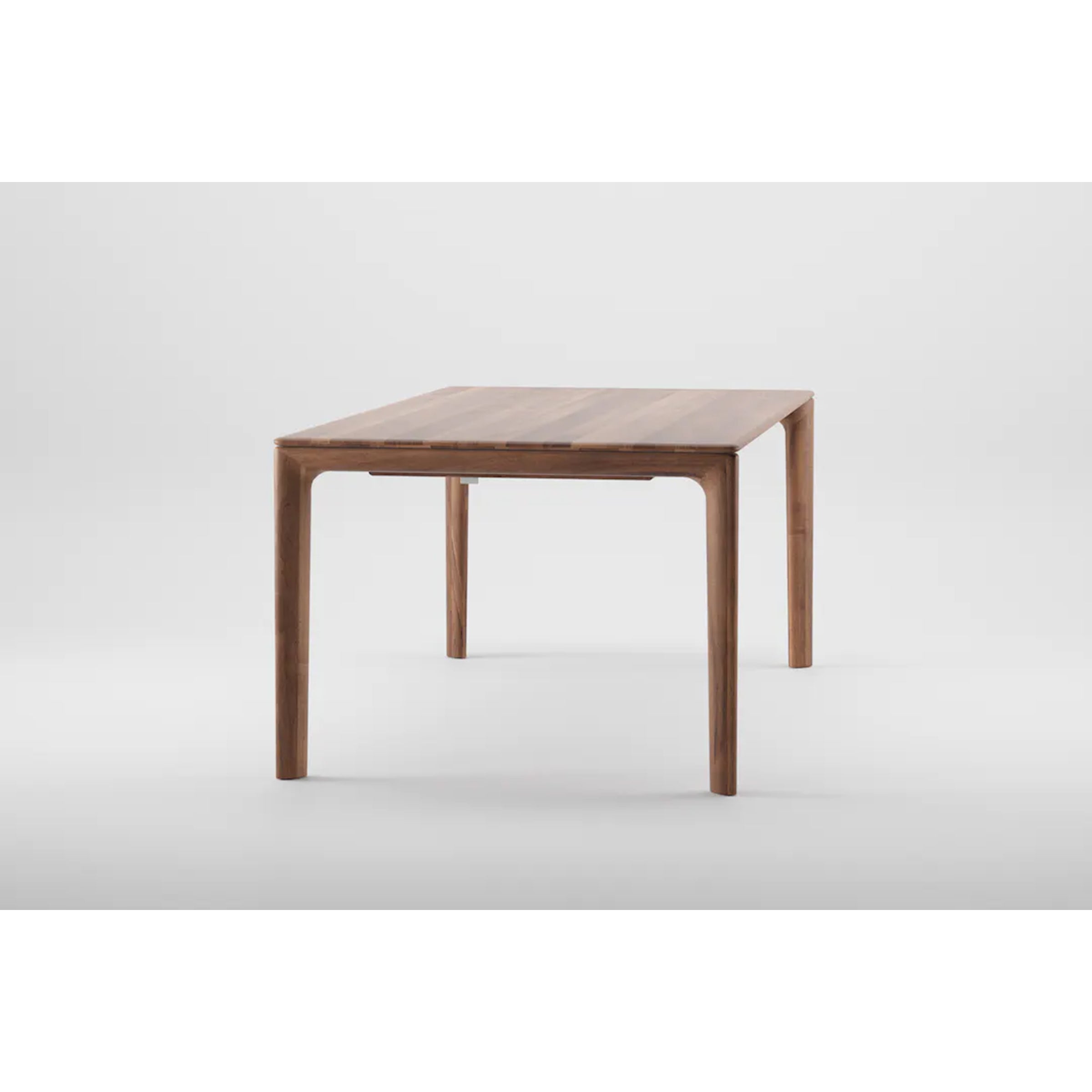 The NEVA Table by Artisan is a minimalist masterpiece with smooth, rounded edges and four straight legs. This handcrafted piece stands elegantly against a plain white background, epitomizing understated sophistication.