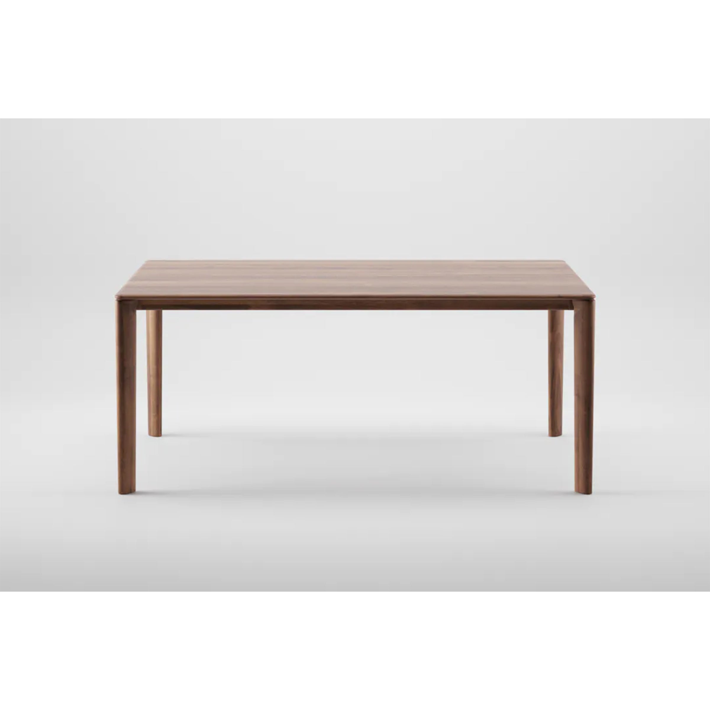The NEVA Table by Artisan is a wooden piece with straight legs and a rectangular top that highlights artisanal craftsmanship. Set on a plain white background, it exudes timeless elegance.